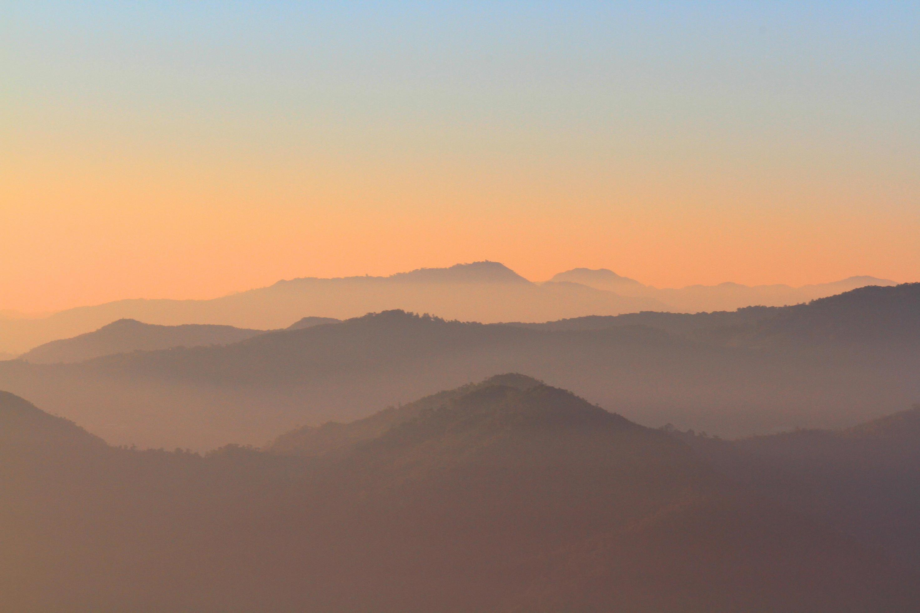 Beautiful Sunset and sunrise on sky and golden twilight time with mist and fog in valley of mountain layer Stock Free