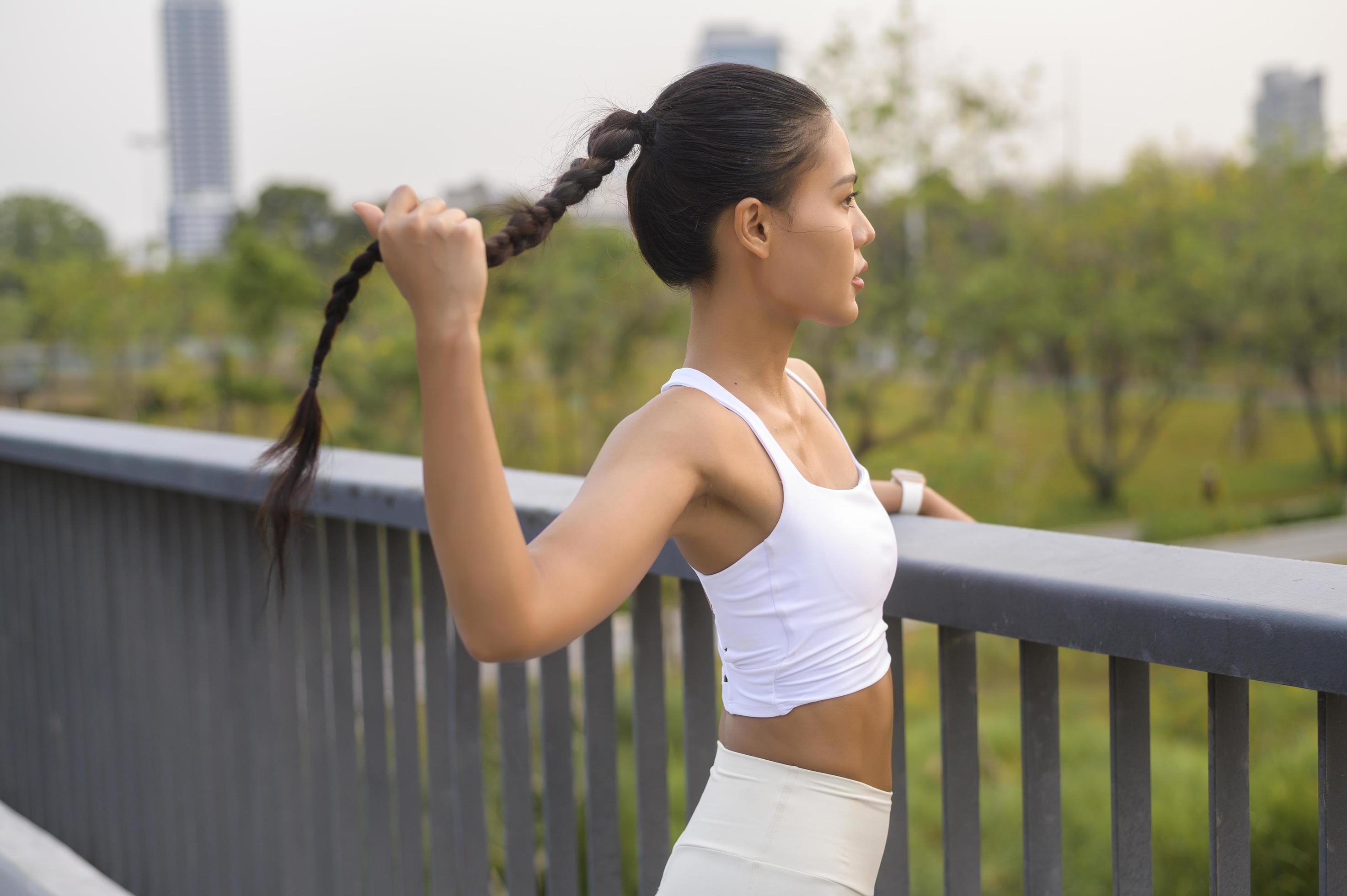 Portrait of young fitness woman in sportswear in city park, Healthy and Lifestyles. Stock Free