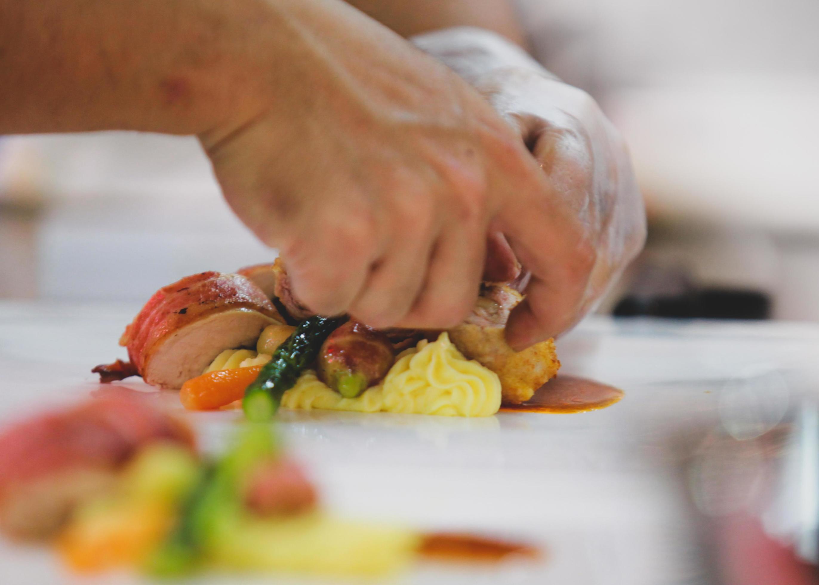 Chef preparing food in the kitchen, chef cooking, Chef decorating dish Stock Free