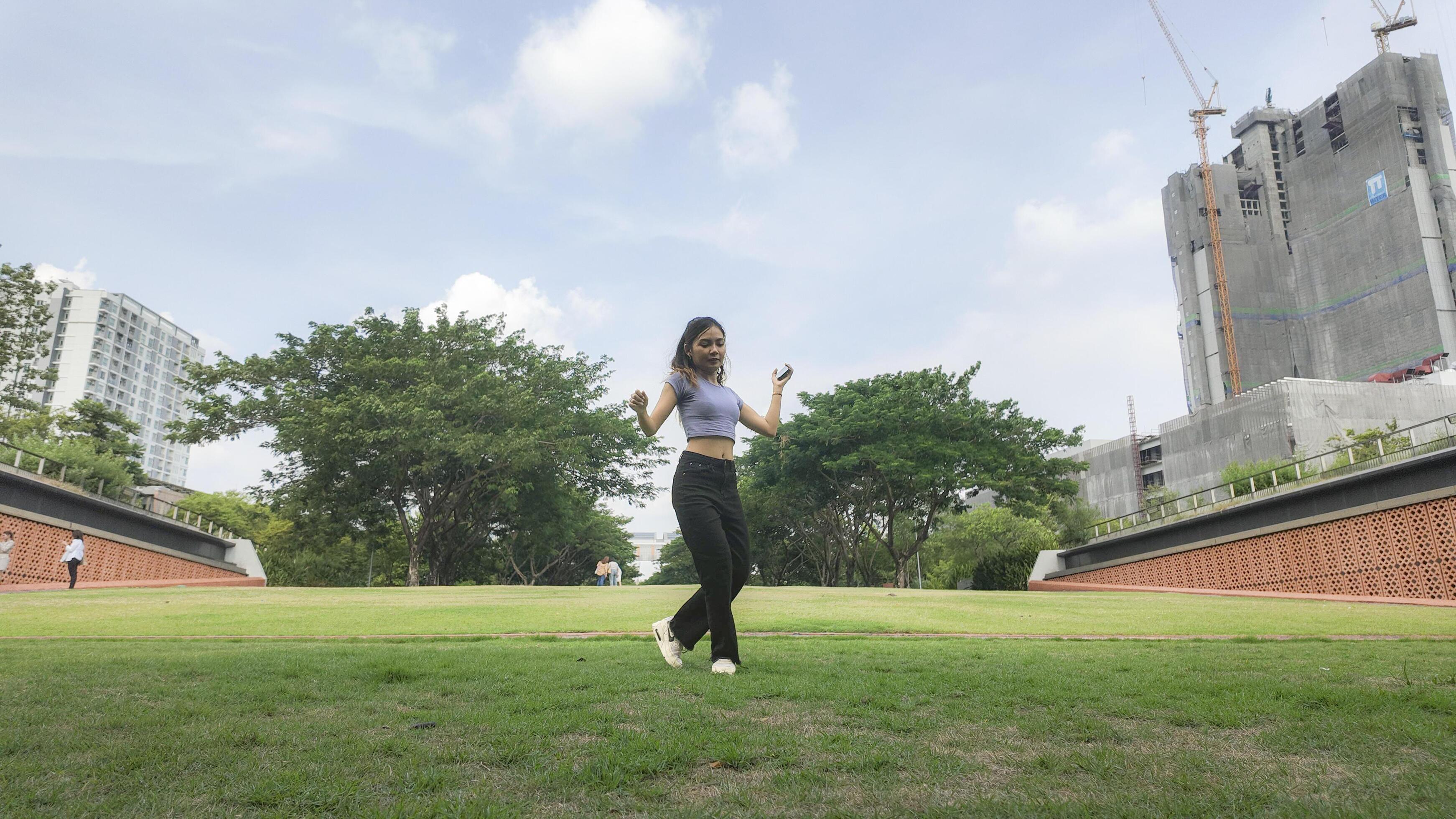 Asian women do freestyle hip hop and breakdancing in a public space in the middle of the city. With a cheerful and happy attitude Stock Free