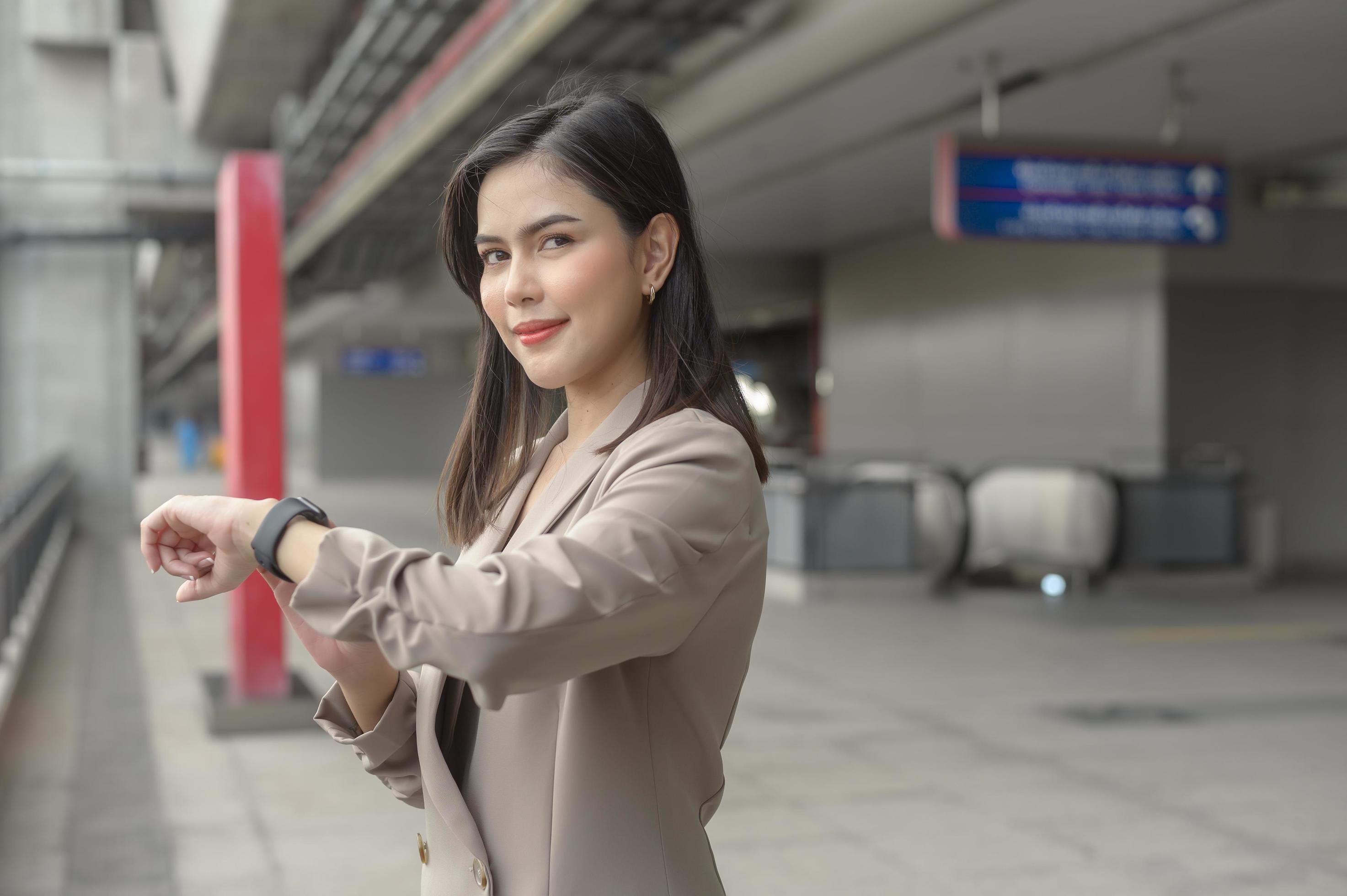 Businesswoman is using Smart watch in Modern city , business technology , city lifestyle concept Stock Free