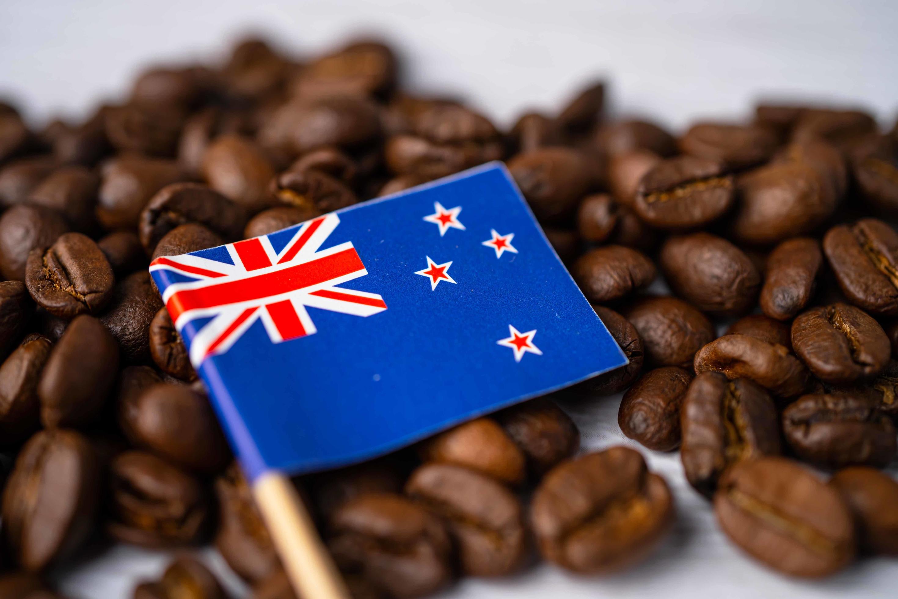 New Zealand flag on coffee beans, import export drink food concept. Stock Free