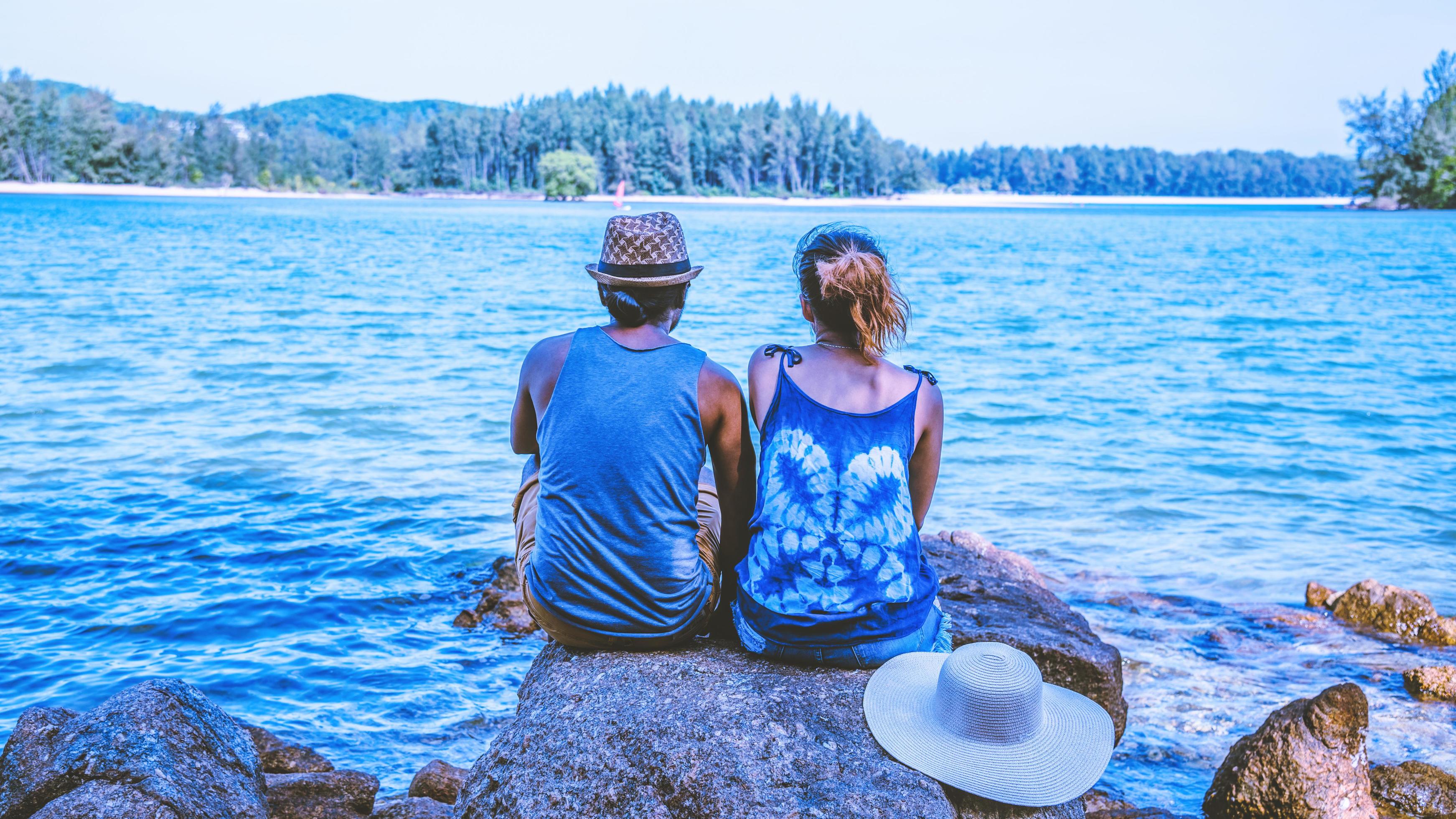 Asian lover woman and man travel nature. Travel relax. On the rocks at the sea. In the summer. Thailand Stock Free