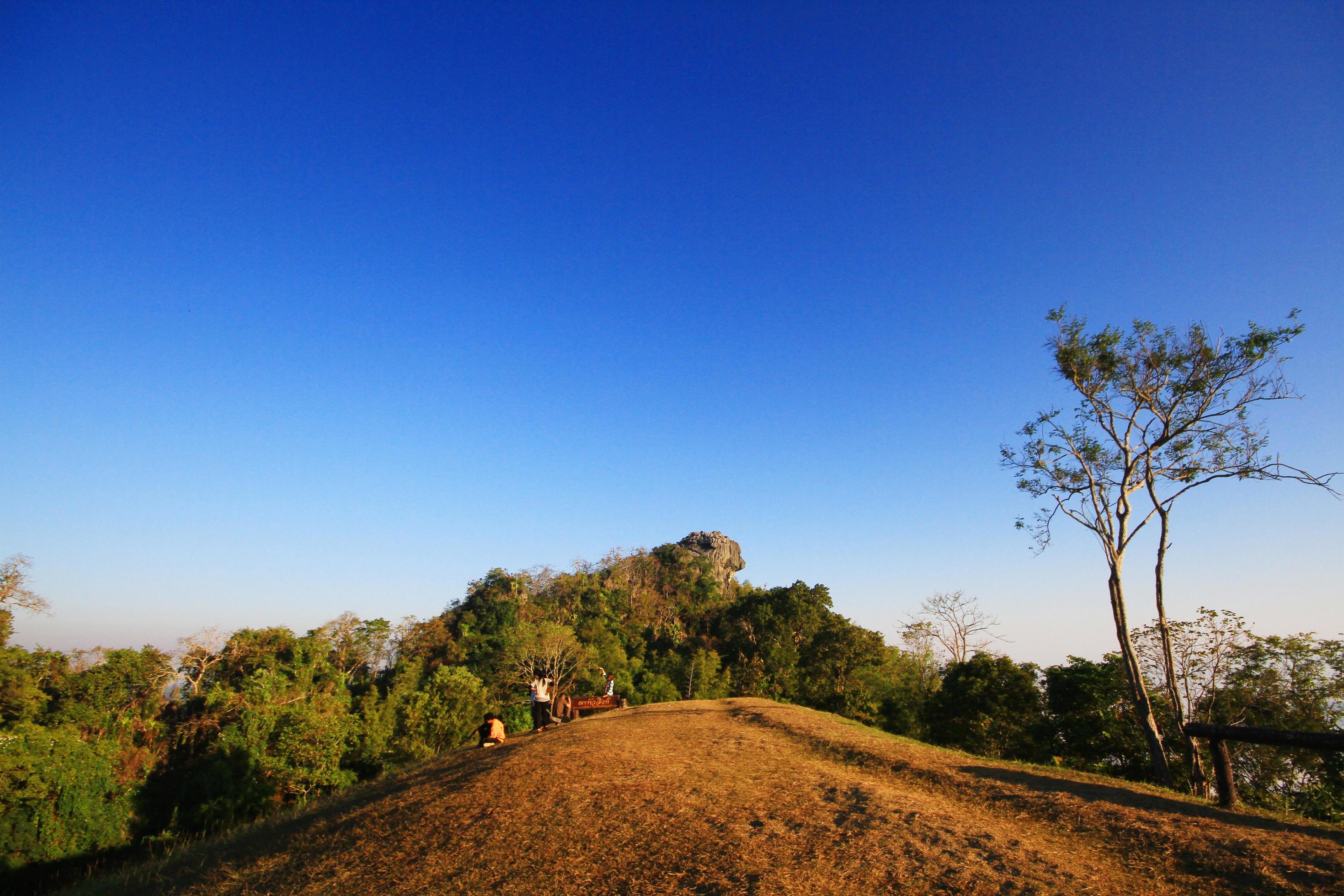 People in golden sunlight shining on the sky and twilight sunrise on the mountain Stock Free