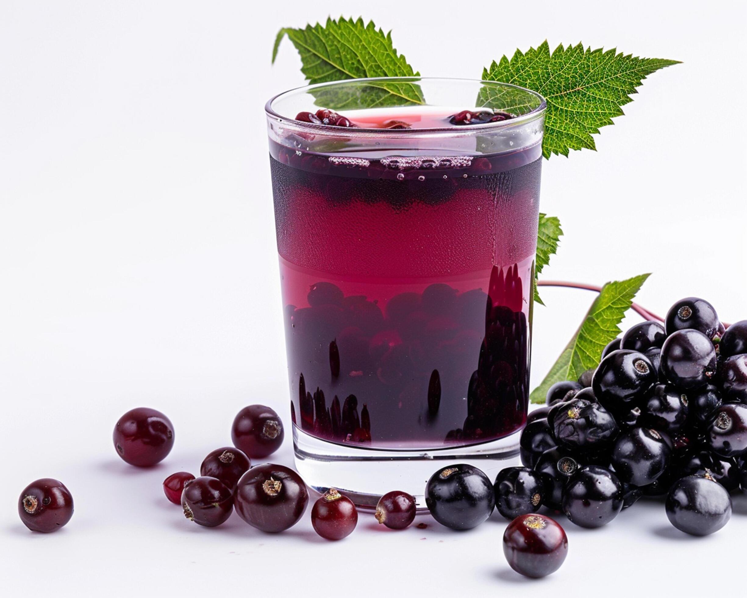 a glass of black currant juice with berries Stock Free