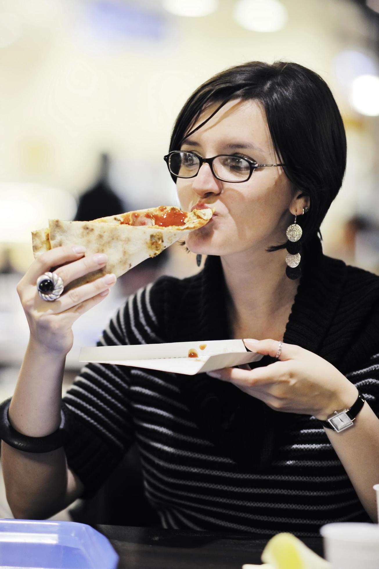 woman eat pizza food at restaurant Stock Free