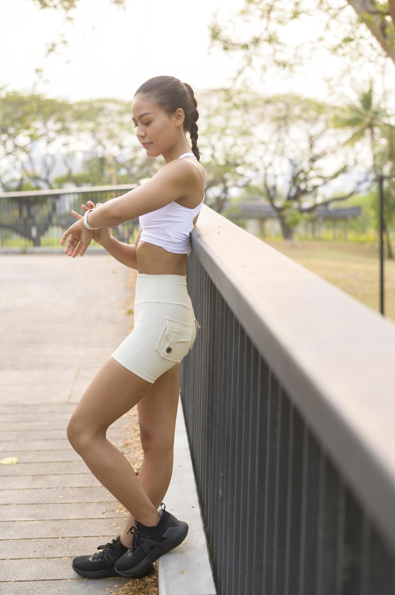 young fitness woman in sportswear using smart watch while exercising in city park, Healthy and Lifestyles Stock Free