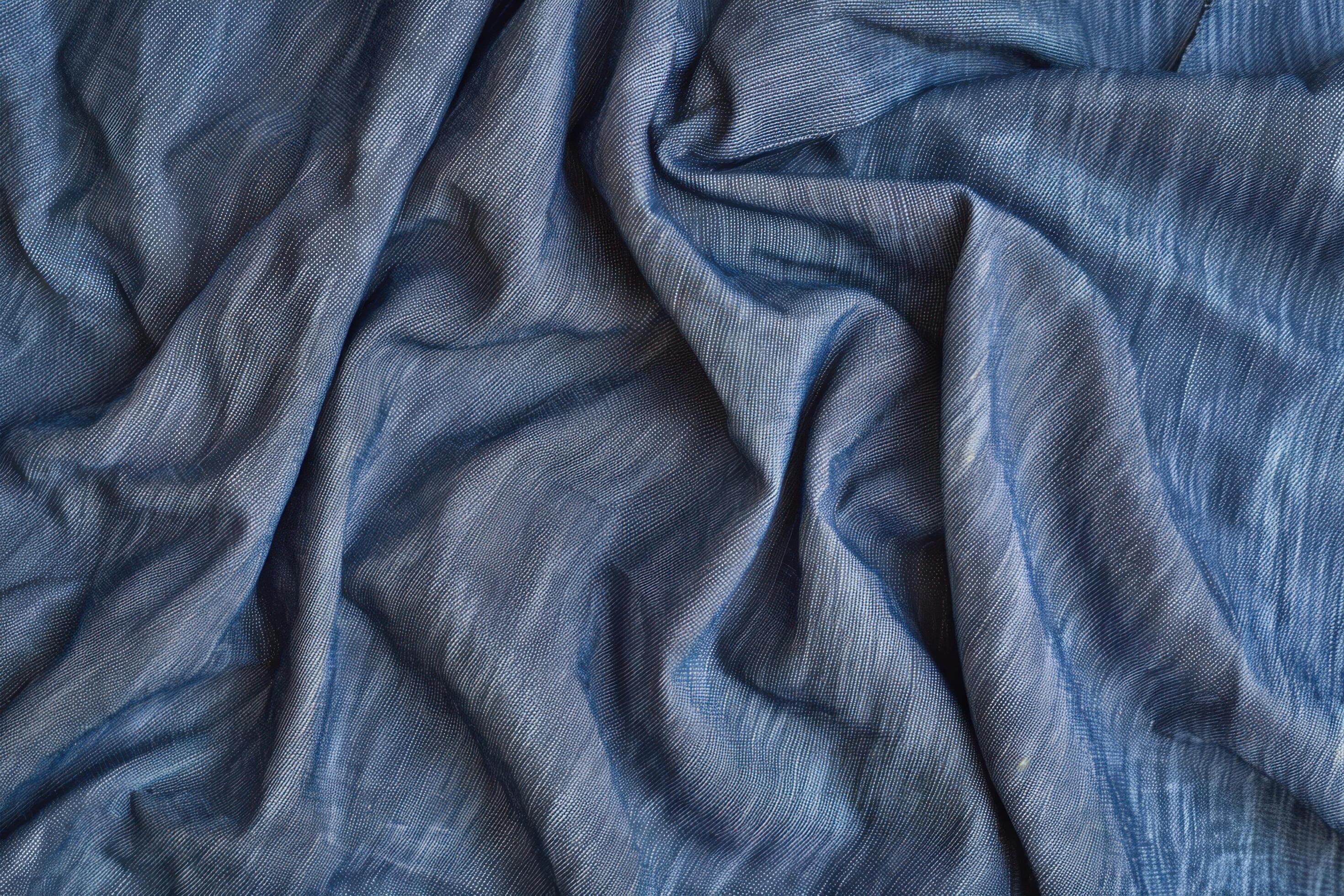 A chambray texture background features a soft, woven fabric look with a subtle, denim-like appearance Stock Free