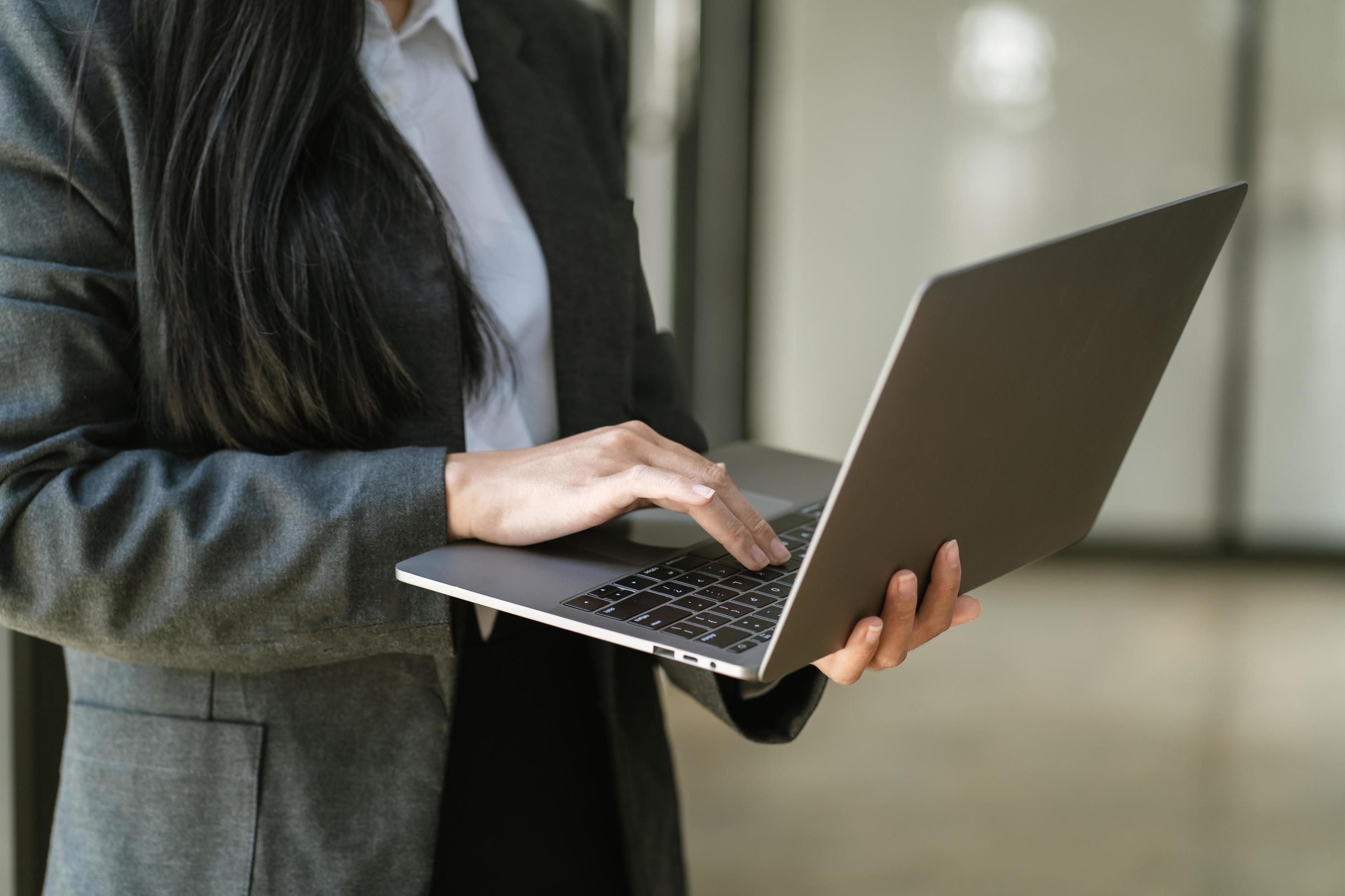 business woman holding laptop computer in office office Stock Free