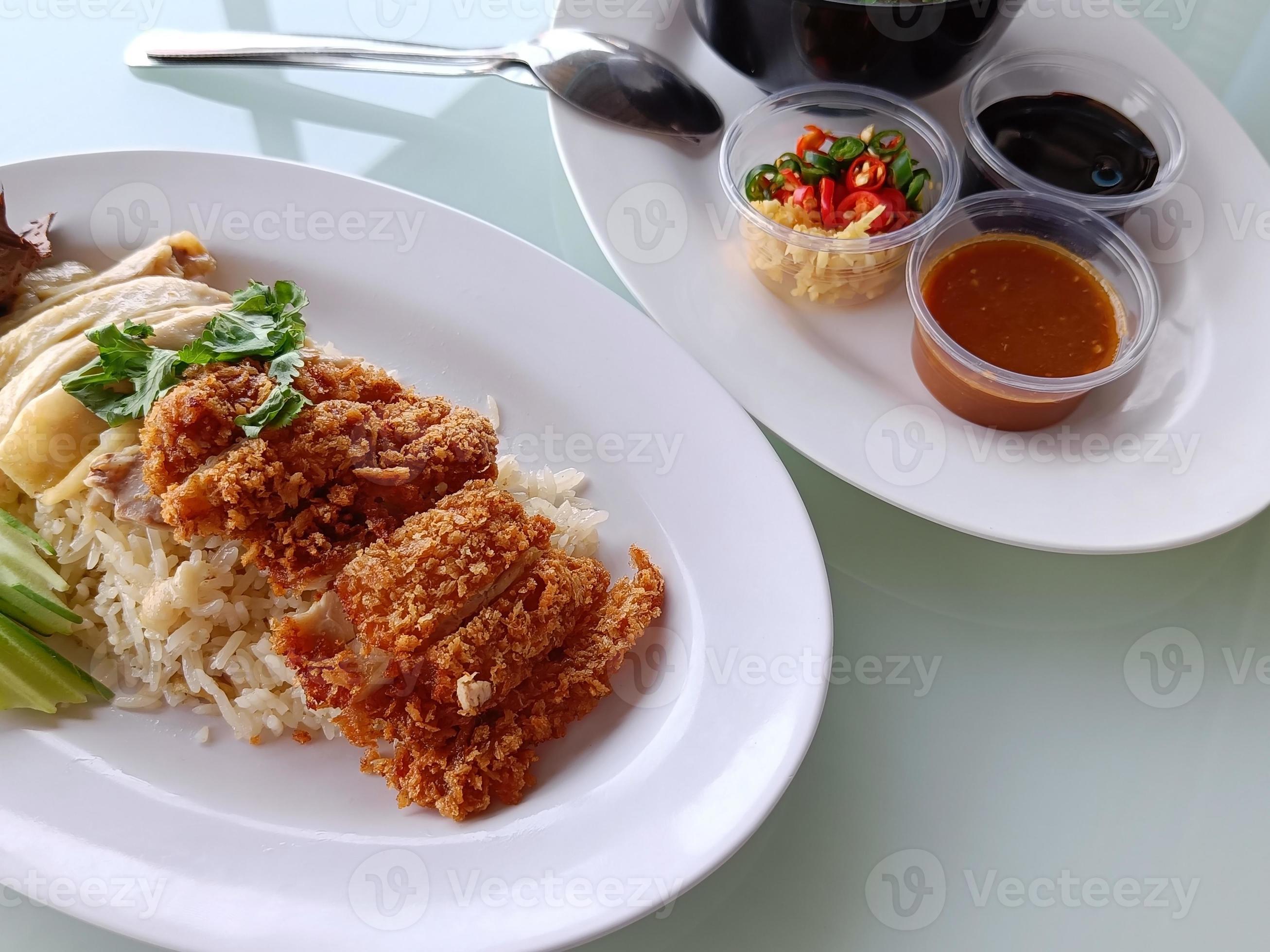 steamed rice topped with boiled chicken Mixed with Fried Chicken, side view. The most popular street food in Thailand is called Khao Mun Gai. Stock Free