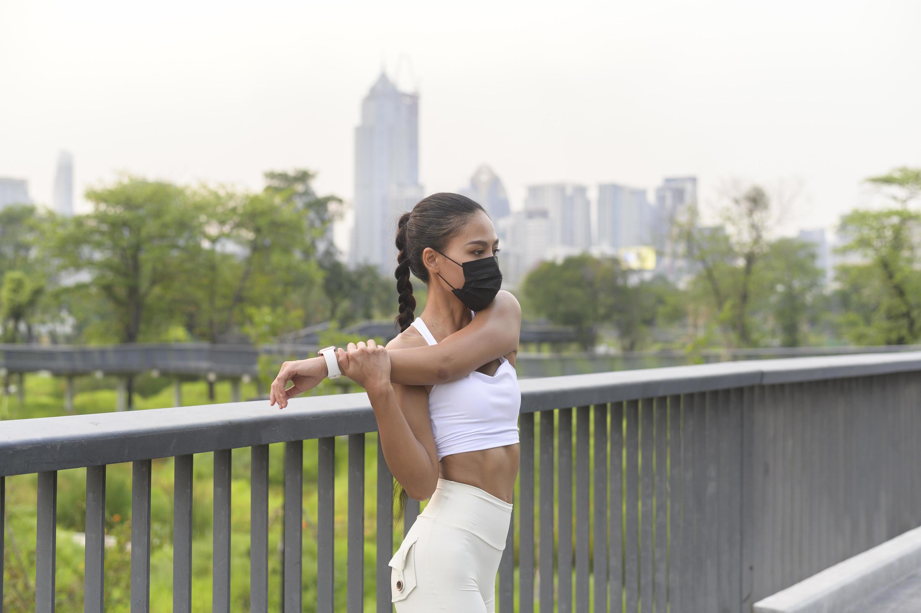 Young fitness woman in sportswear taking face mask in while exercise in city park, Health and Lifestyles. Stock Free