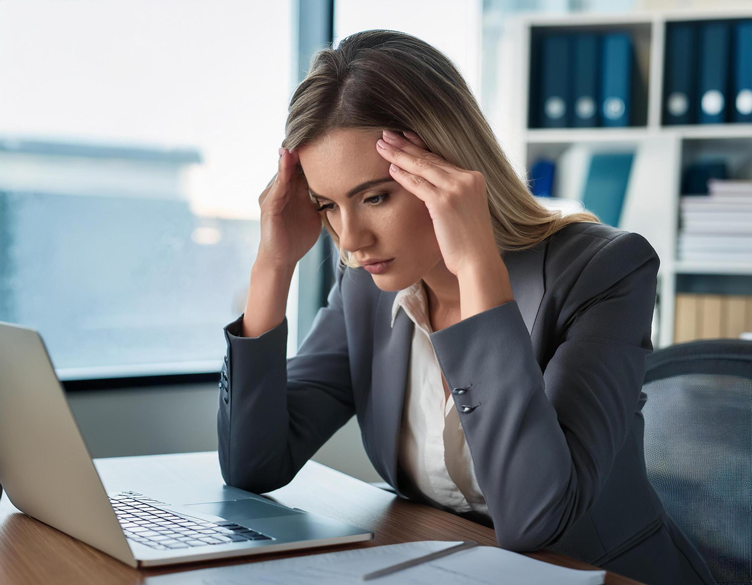 Young caucasian business woman in her 30s in front of laptop looking stressed, upset, worried, at work. Stock Free