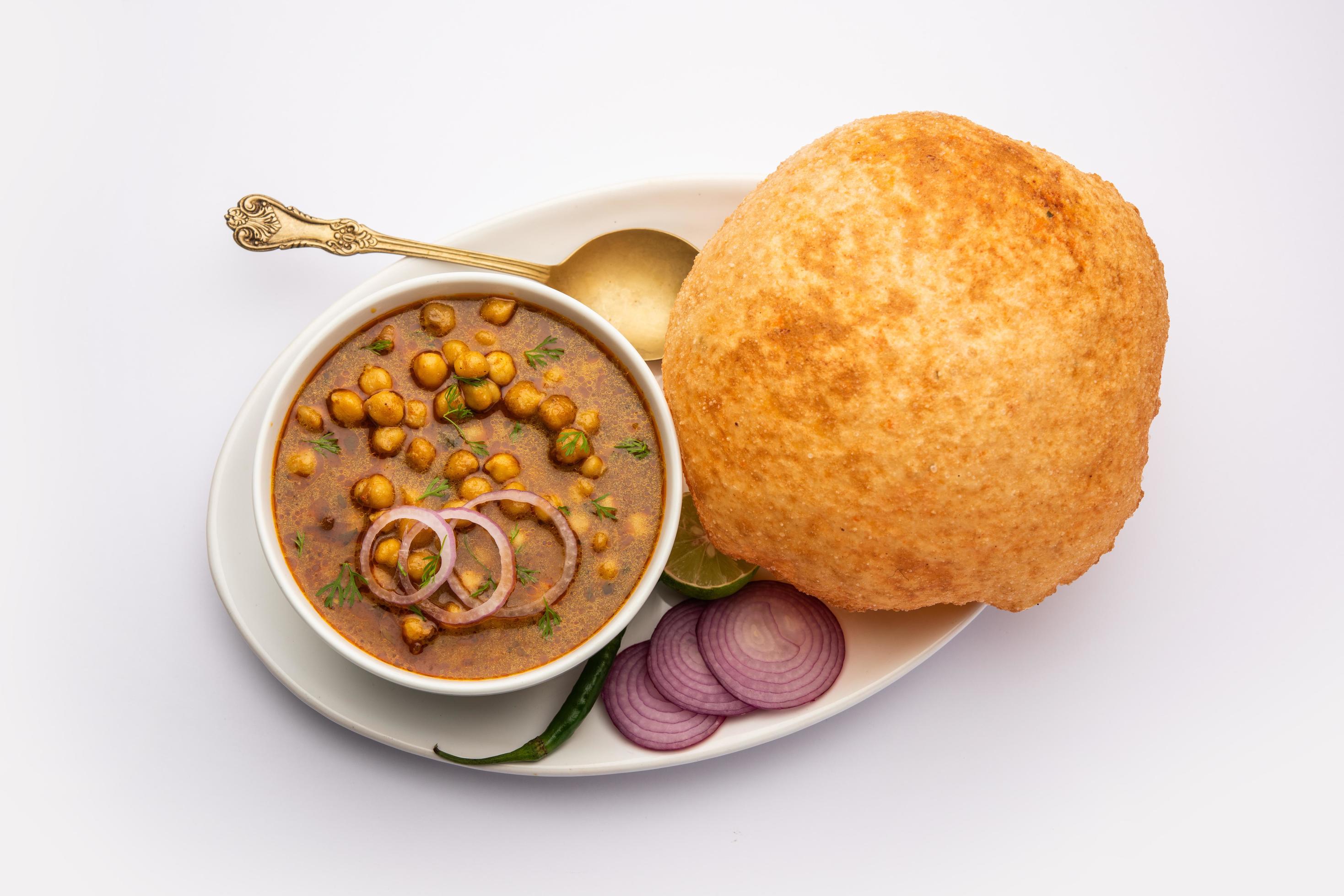 Chole bhature is a North Indian food dish. A combination of chana masala and bhatura or puri Stock Free