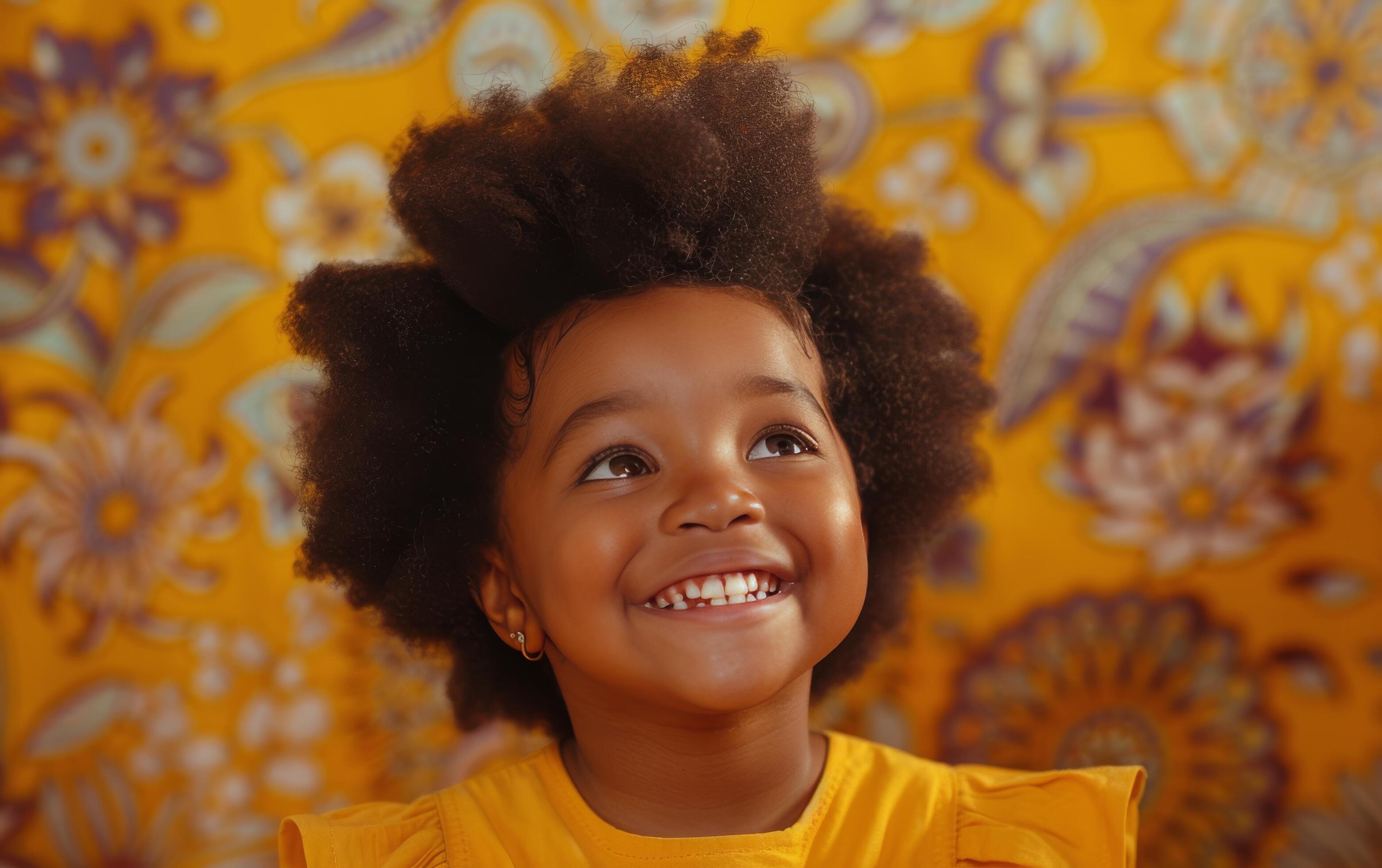 Young Girl With Curly Hair Smiles Against Colorful Floral Wall Stock Free