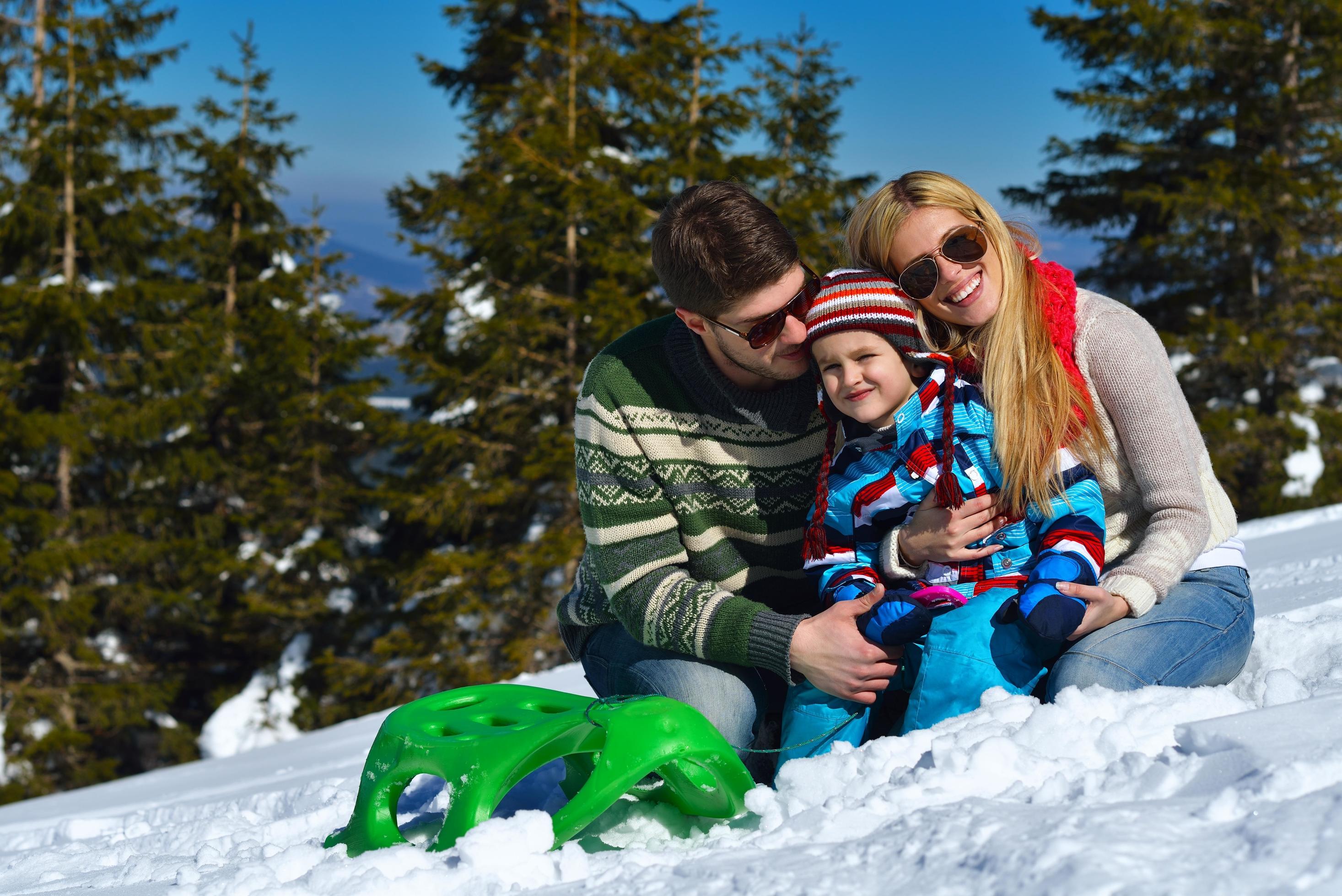 family having fun on fresh snow at winter Stock Free