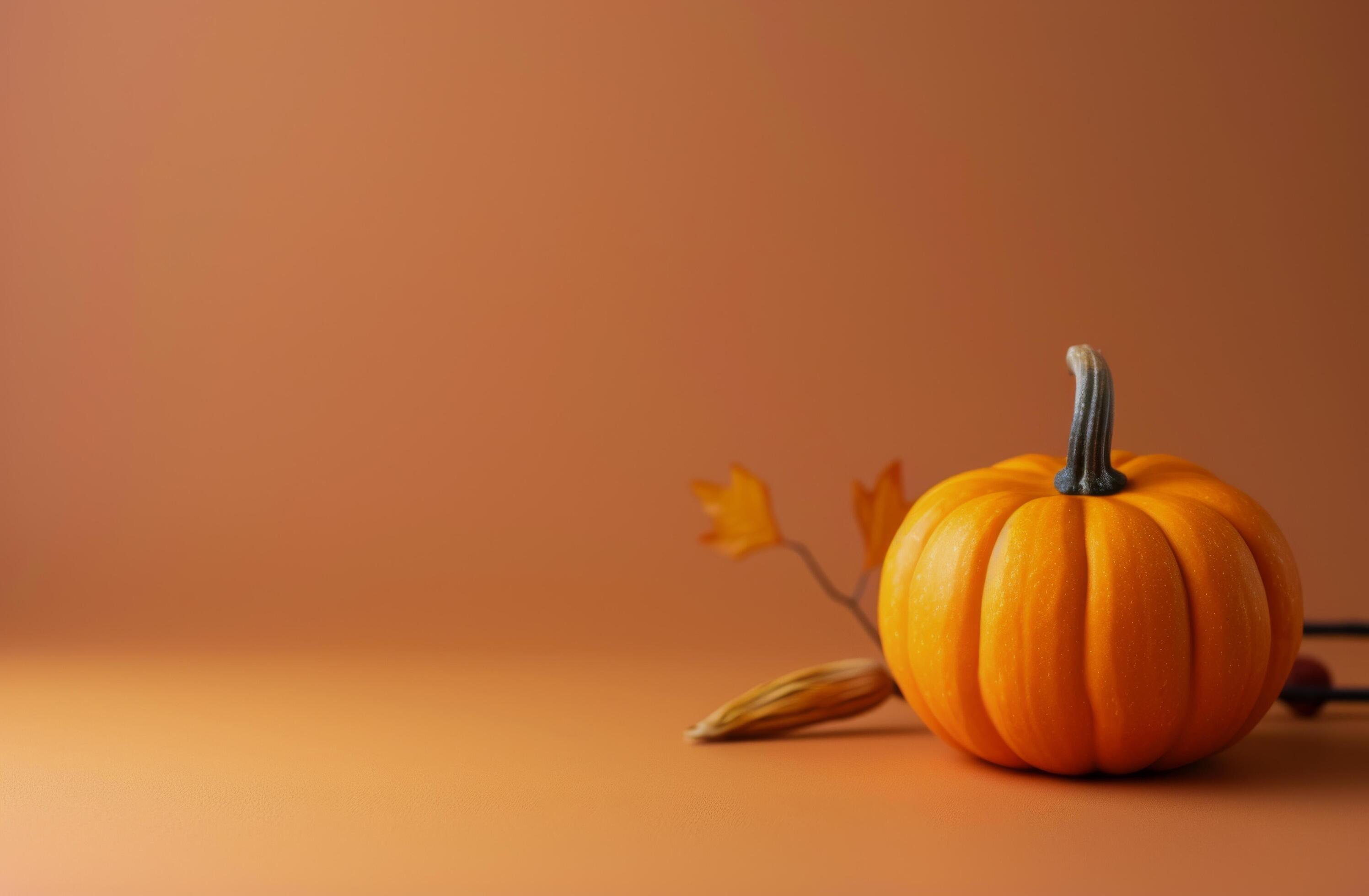 Vibrant Orange Pumpkin With Autumn Leaves on Warm Background Stock Free