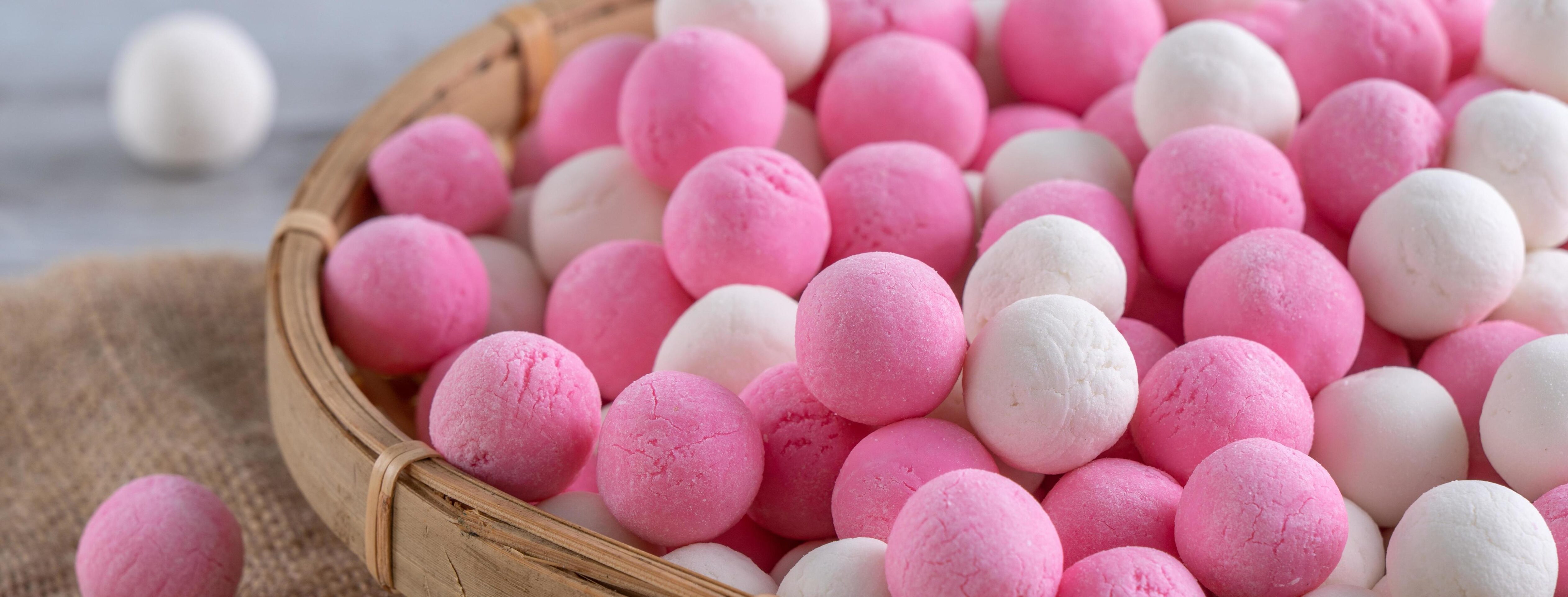 Raw red and white tangyuan on wooden table background for Winter solstice food. Stock Free