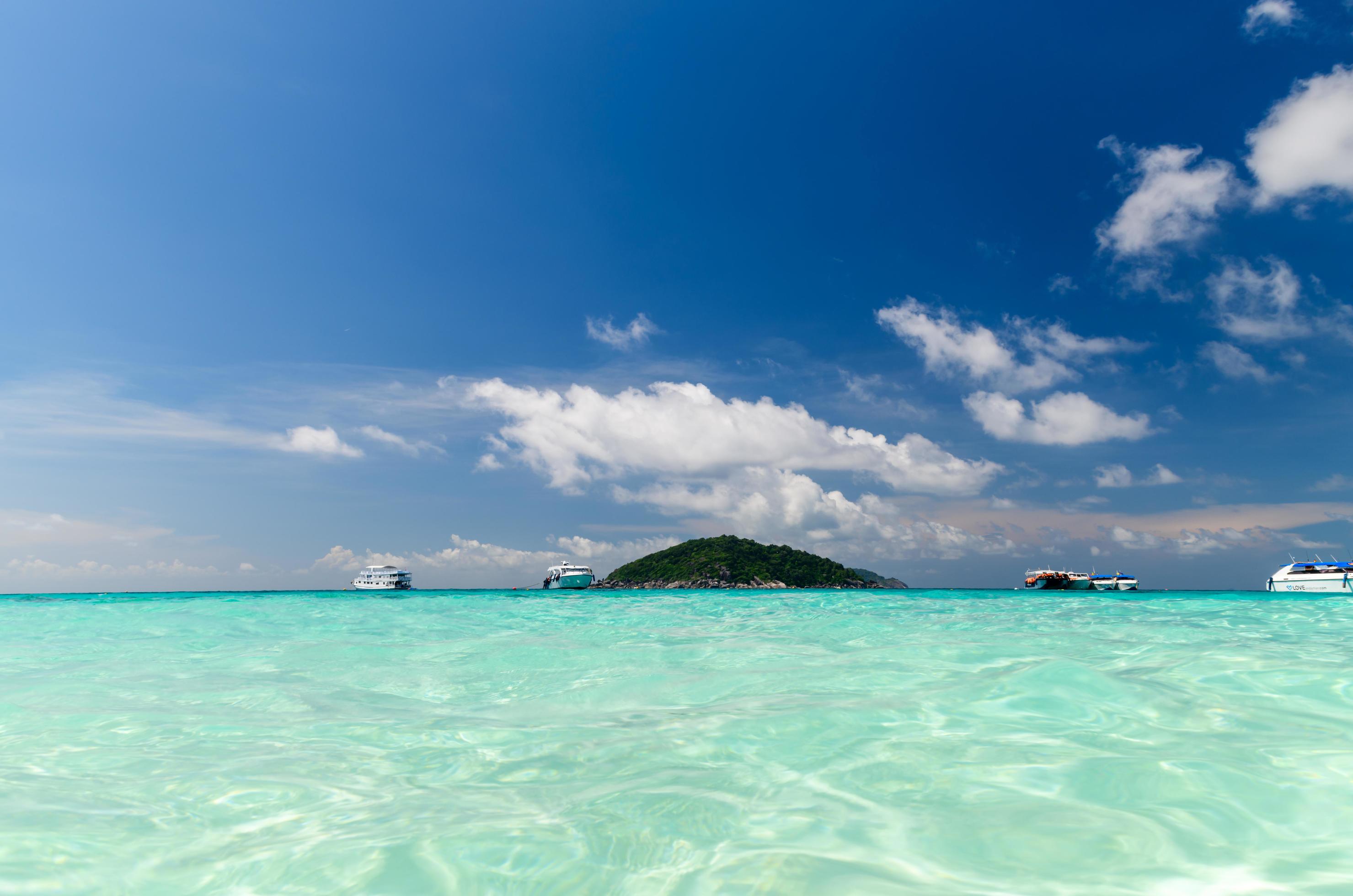 Speed boat on clear sea with white cloudy and blue sky at Similan Island, phang-nga Thailand Stock Free