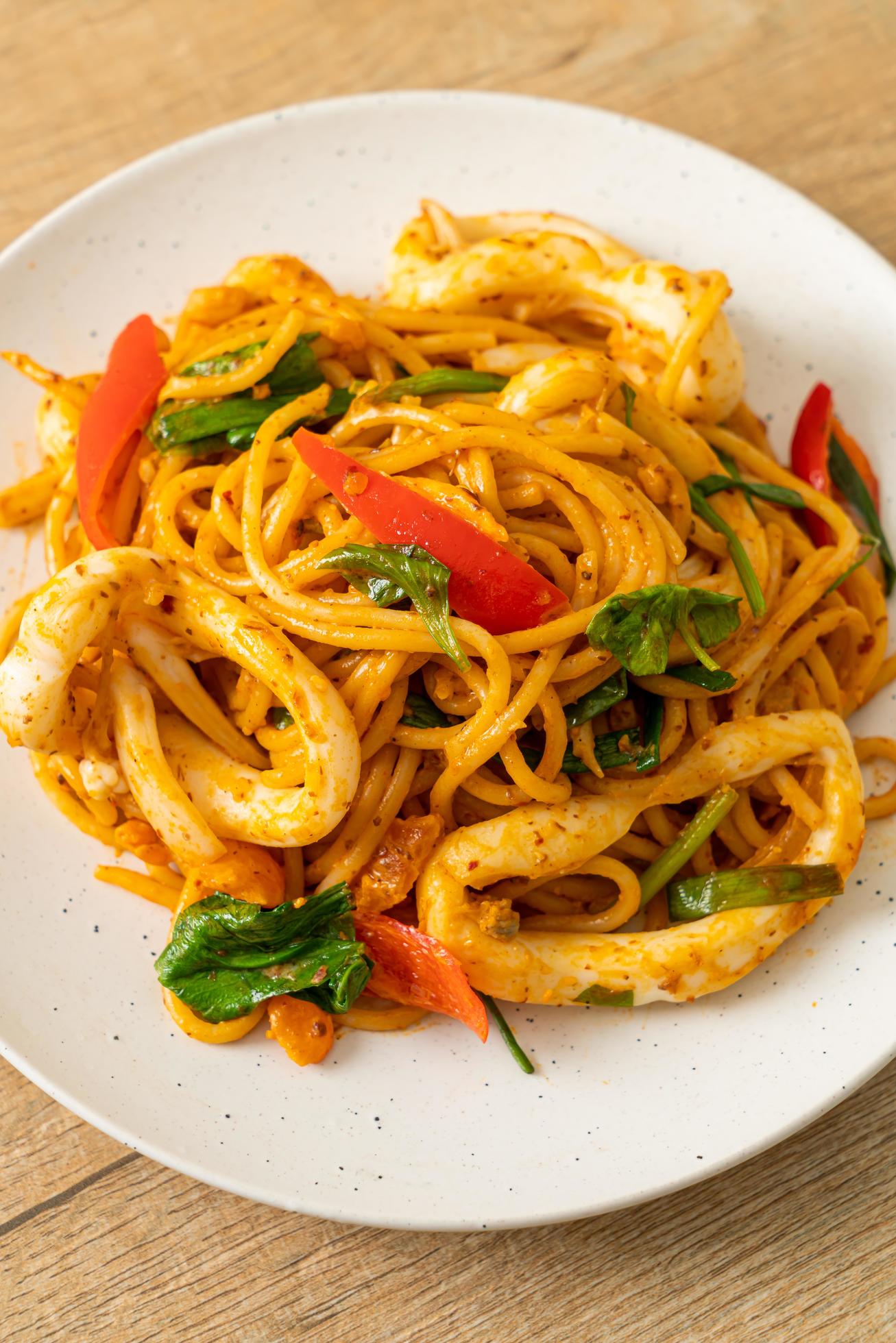 Stir-fried spaghetti with salted egg and squid – fusion food style Stock Free