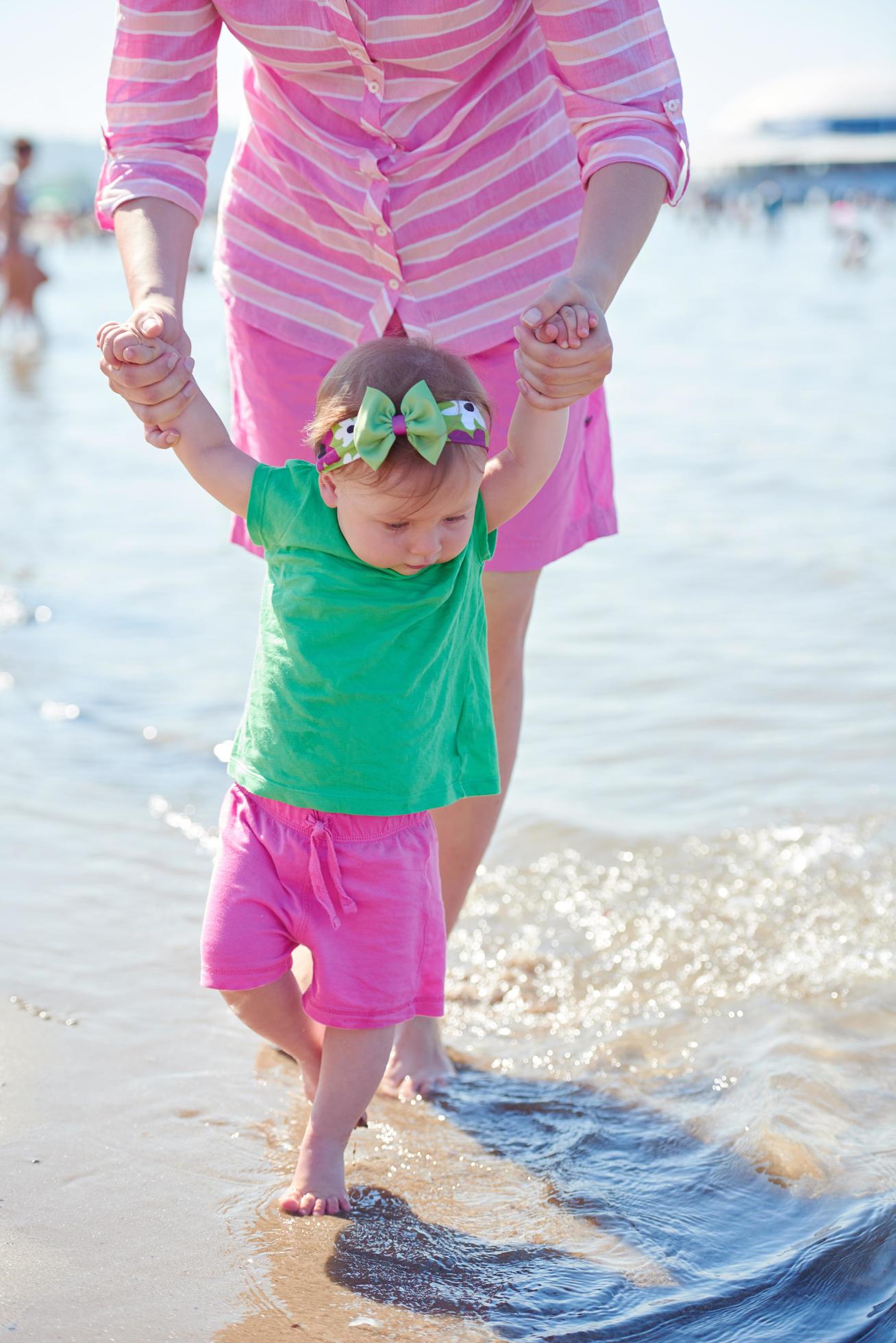 mom and baby on beach have fun Stock Free