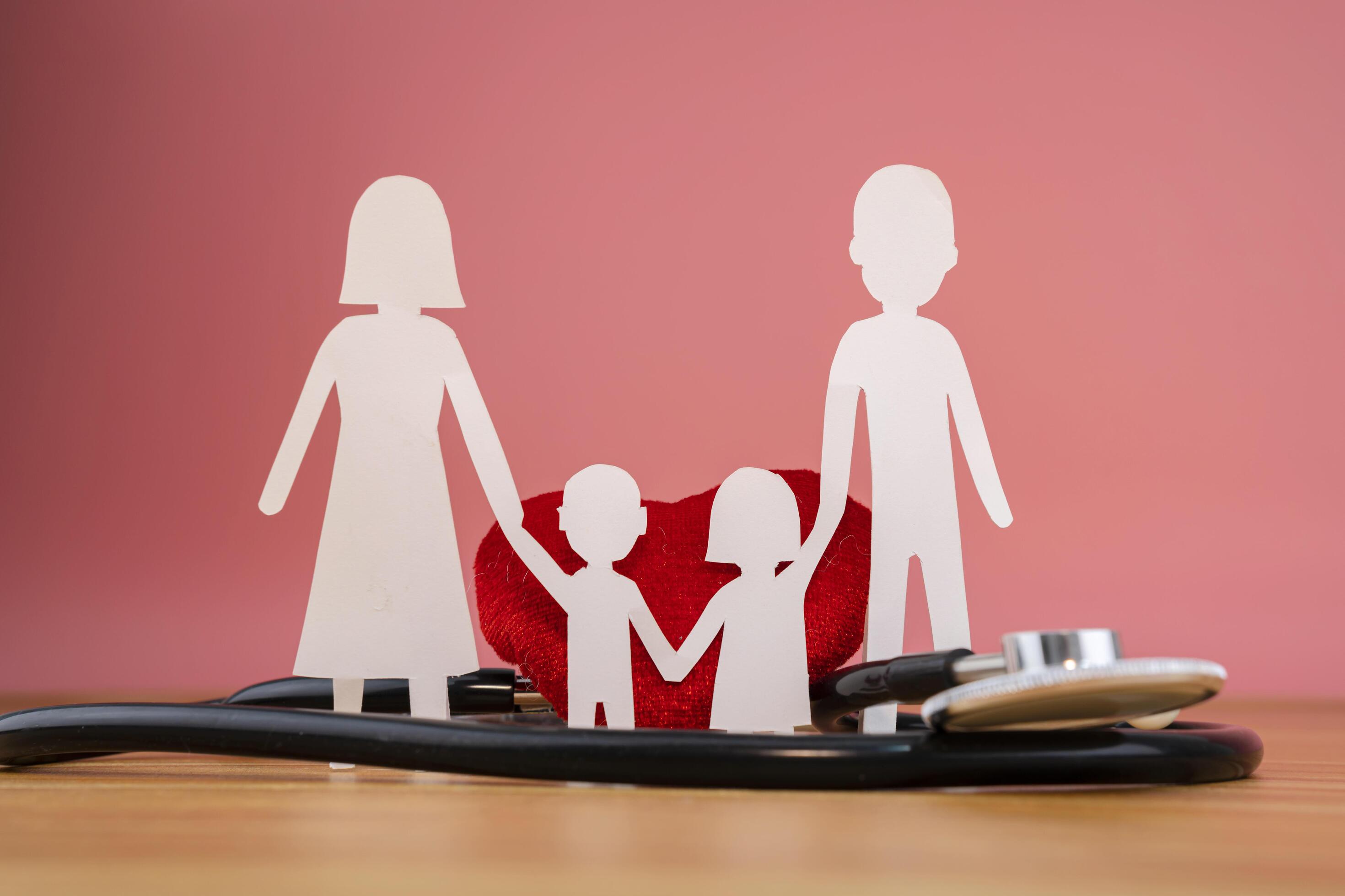 Stethoscope, heart of family on wooden background Stock Free