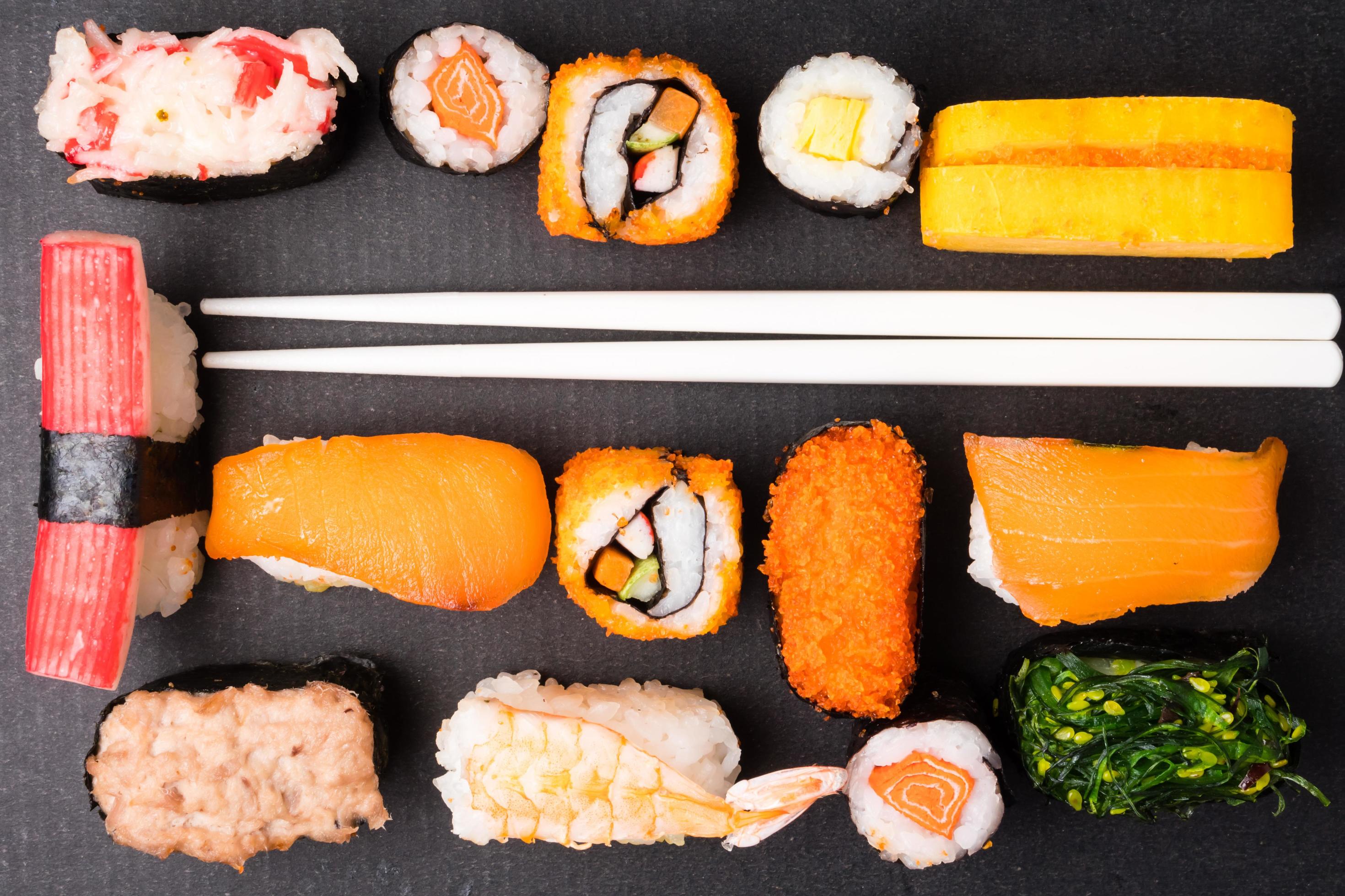 Top view of Sushi set and chopsticks on black background, Japanese food. Stock Free