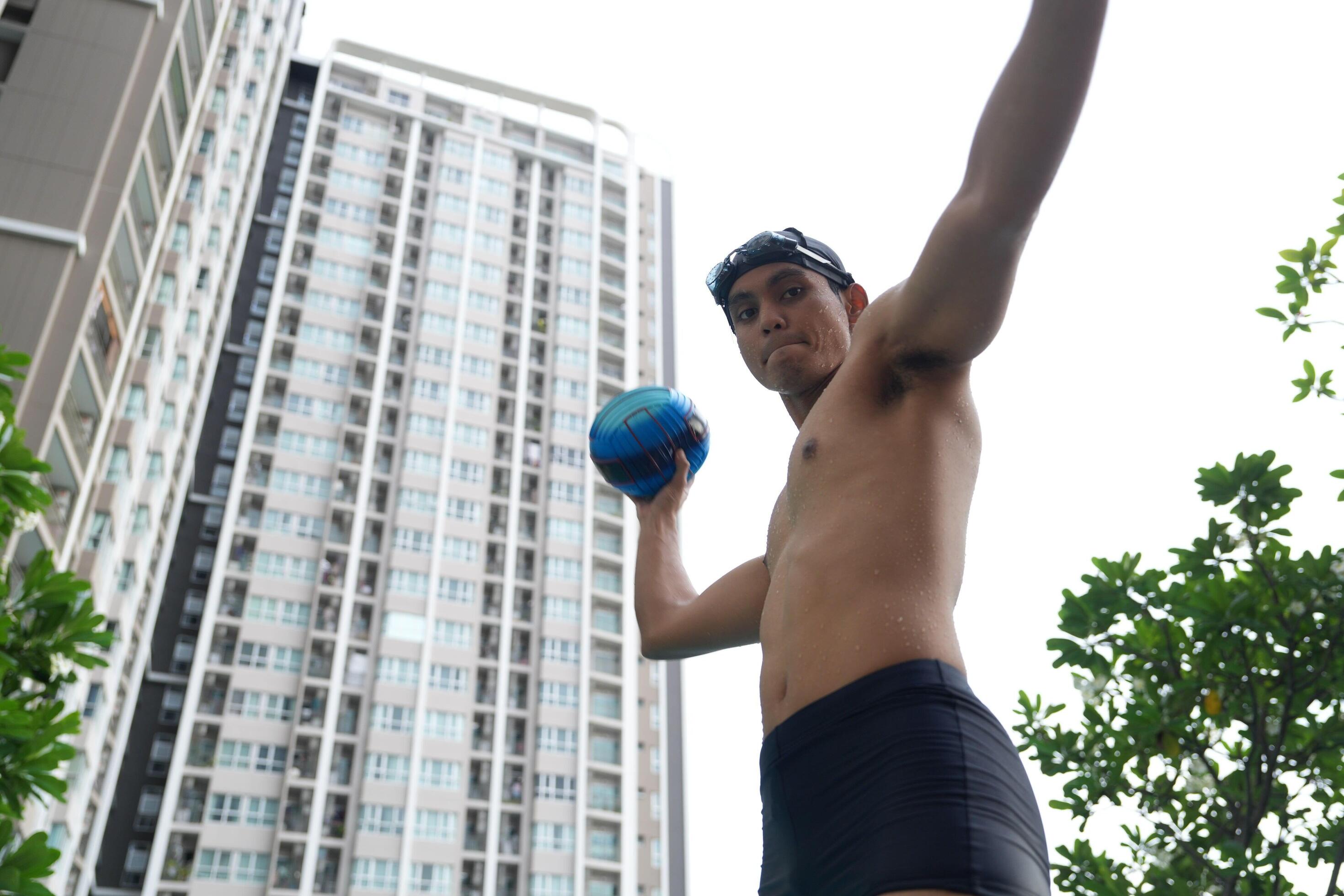 Asian men practicing swimming and preparing to play water polo and stretching and resting for water sports. Stock Free