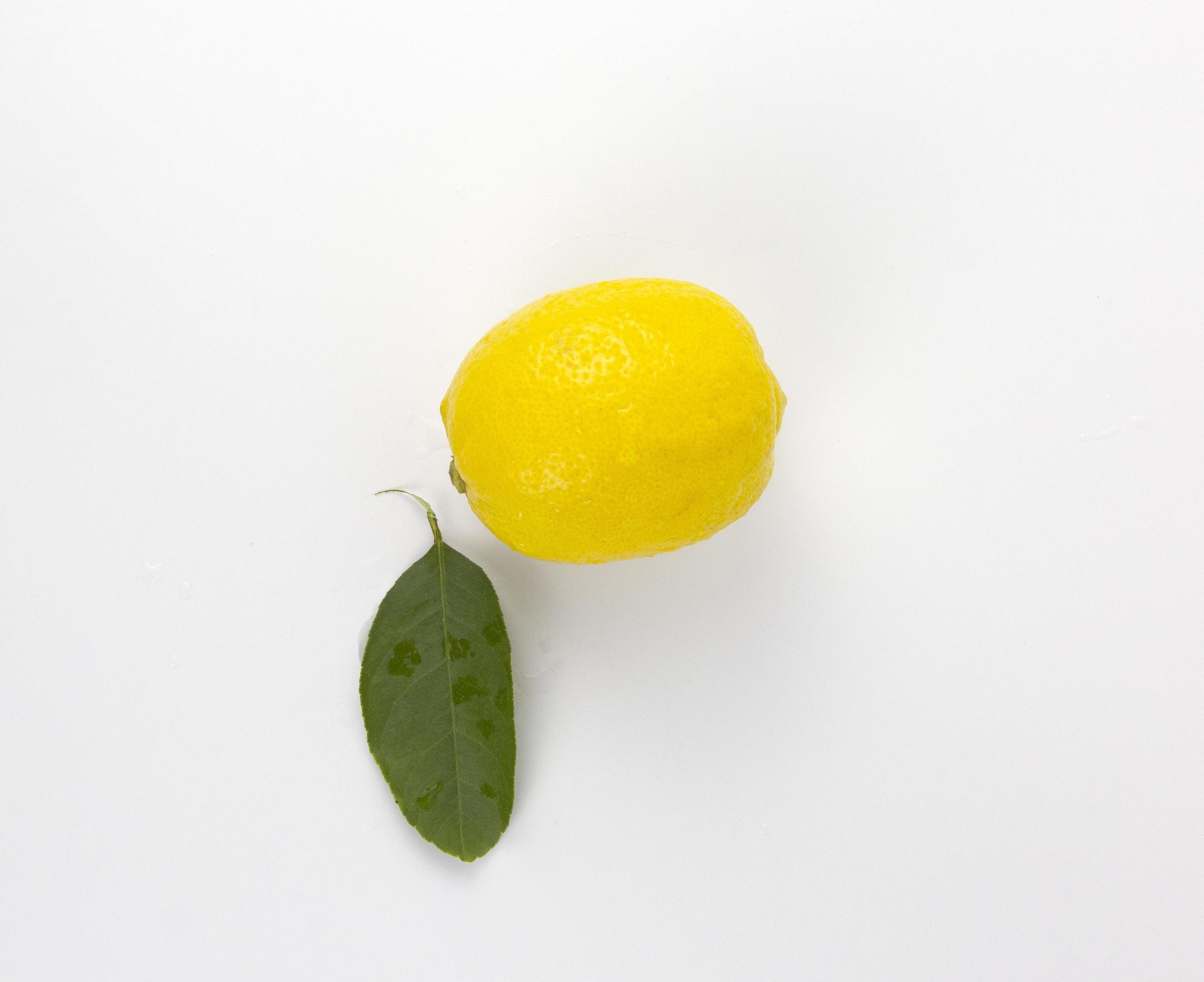 A Fresh yellow Lemon fruit with leaf isolated on white background used in healthy food diet concept Stock Free