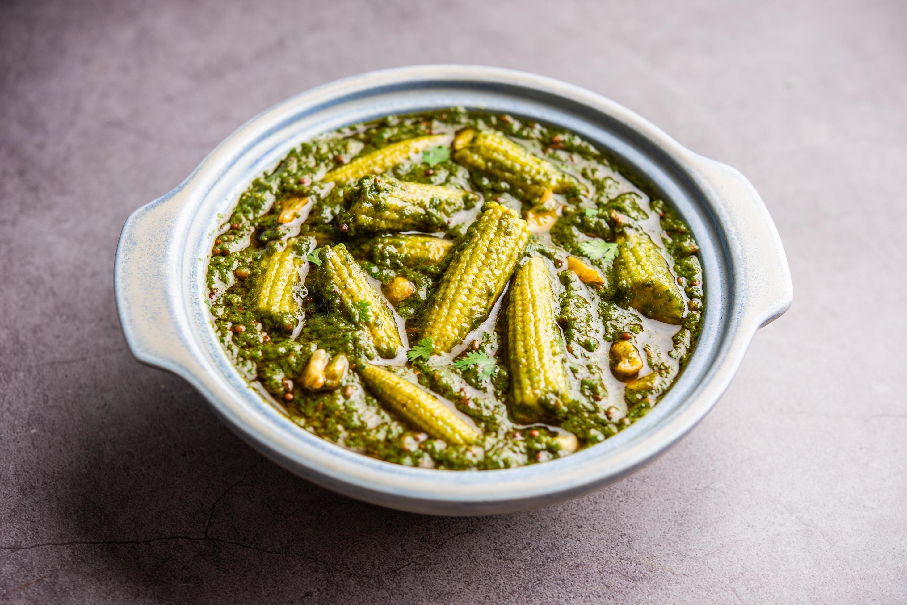 palak baby corn sabzi also known as spinach makai curry served with rice or roti, Indian food Stock Free