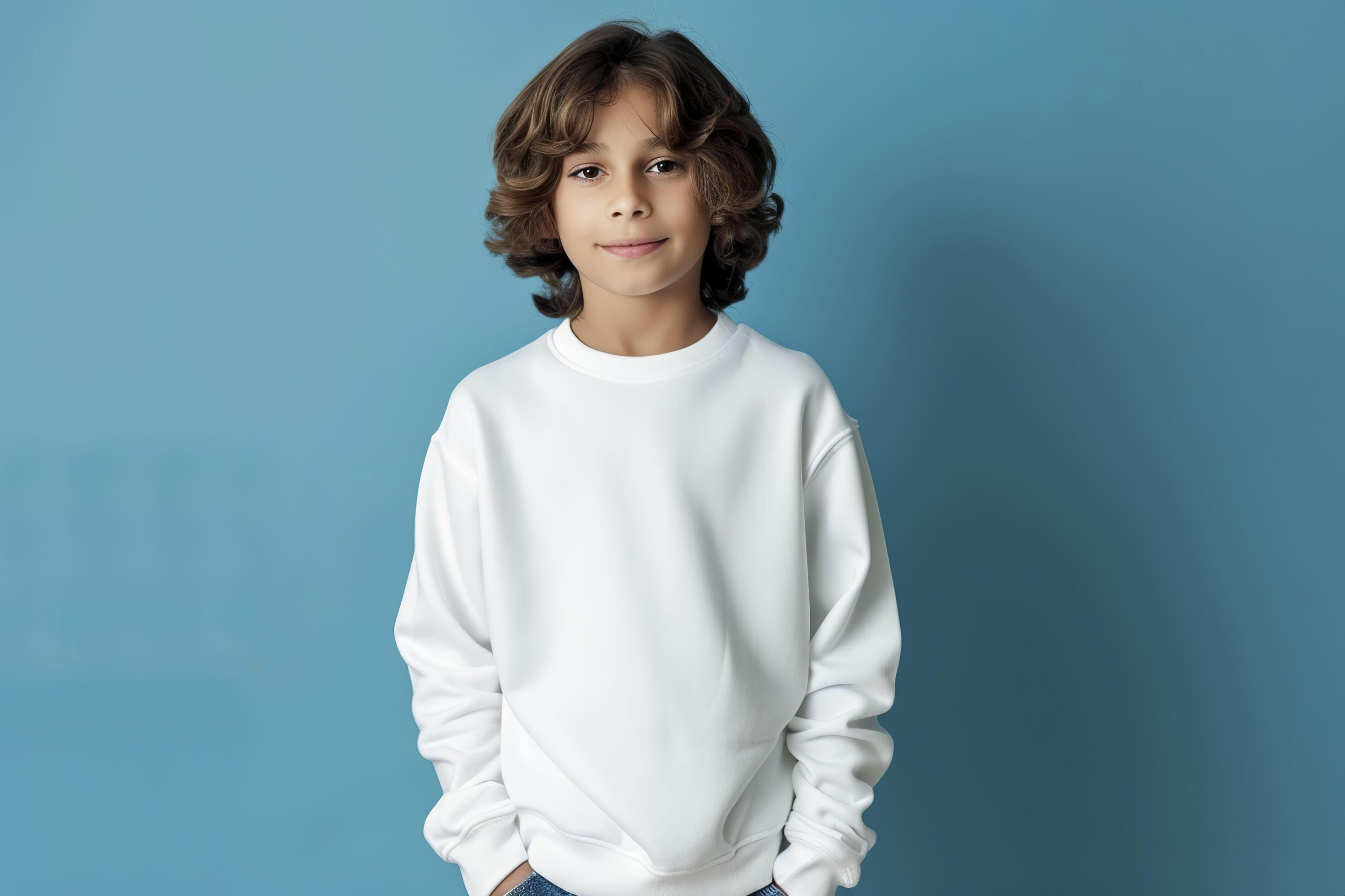 Cute boy in a white sweatshirt on blue background. Kids sweatshirt mockup. Stock Free