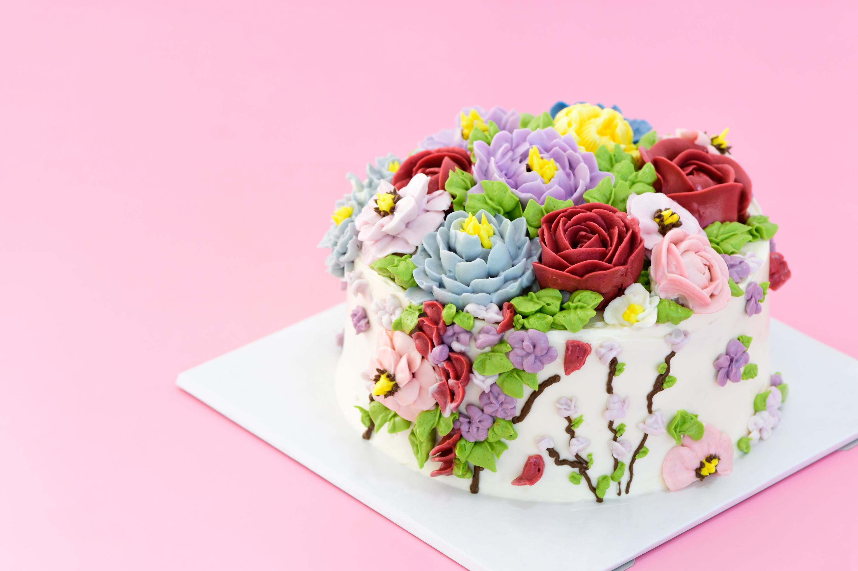 Homemade cake decorated with beautiful flowers on pink background, Stock Free