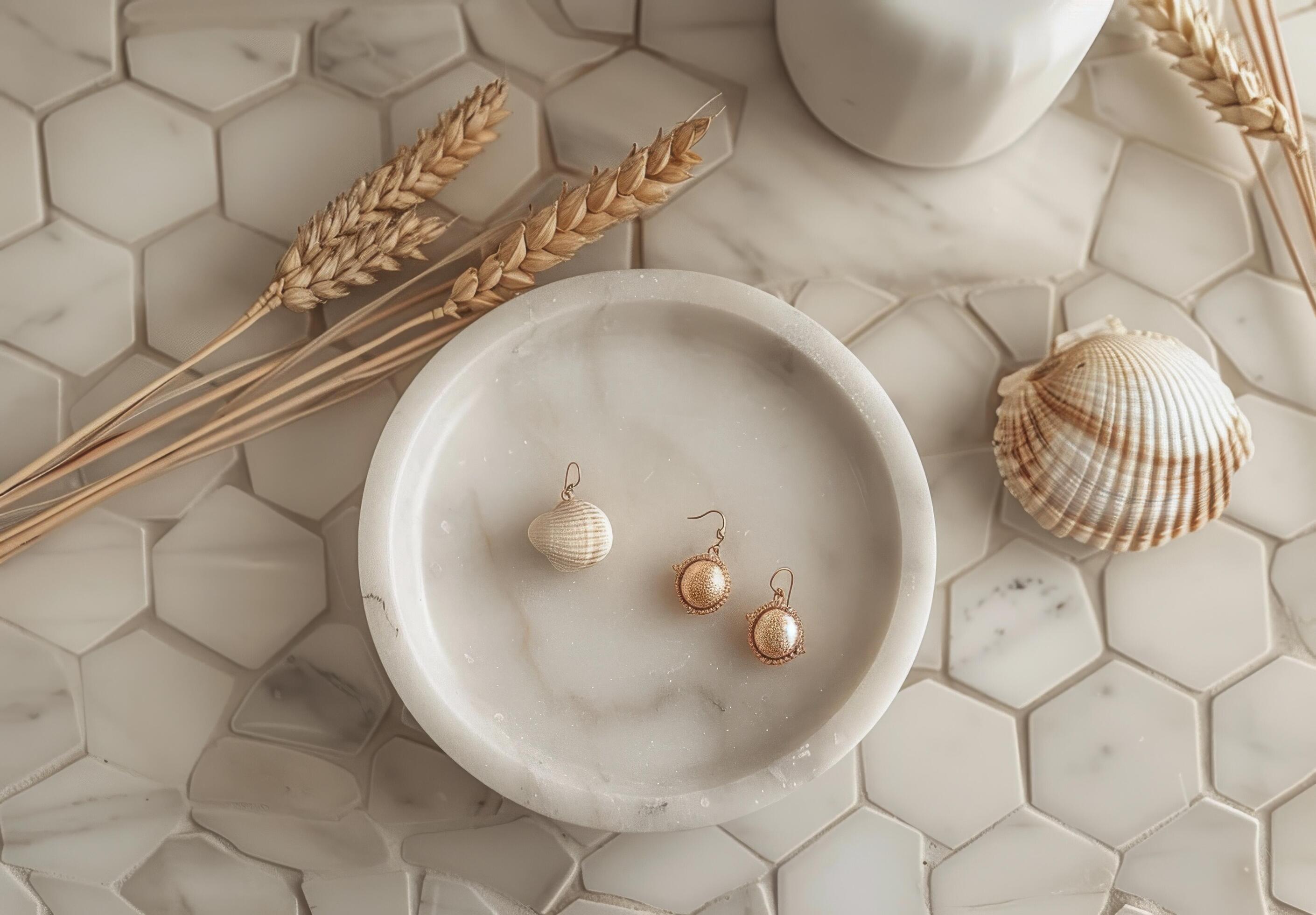 Gold Round Diamond Stud Earrings on White Marble Tray With Seashell and Wheat Stock Free