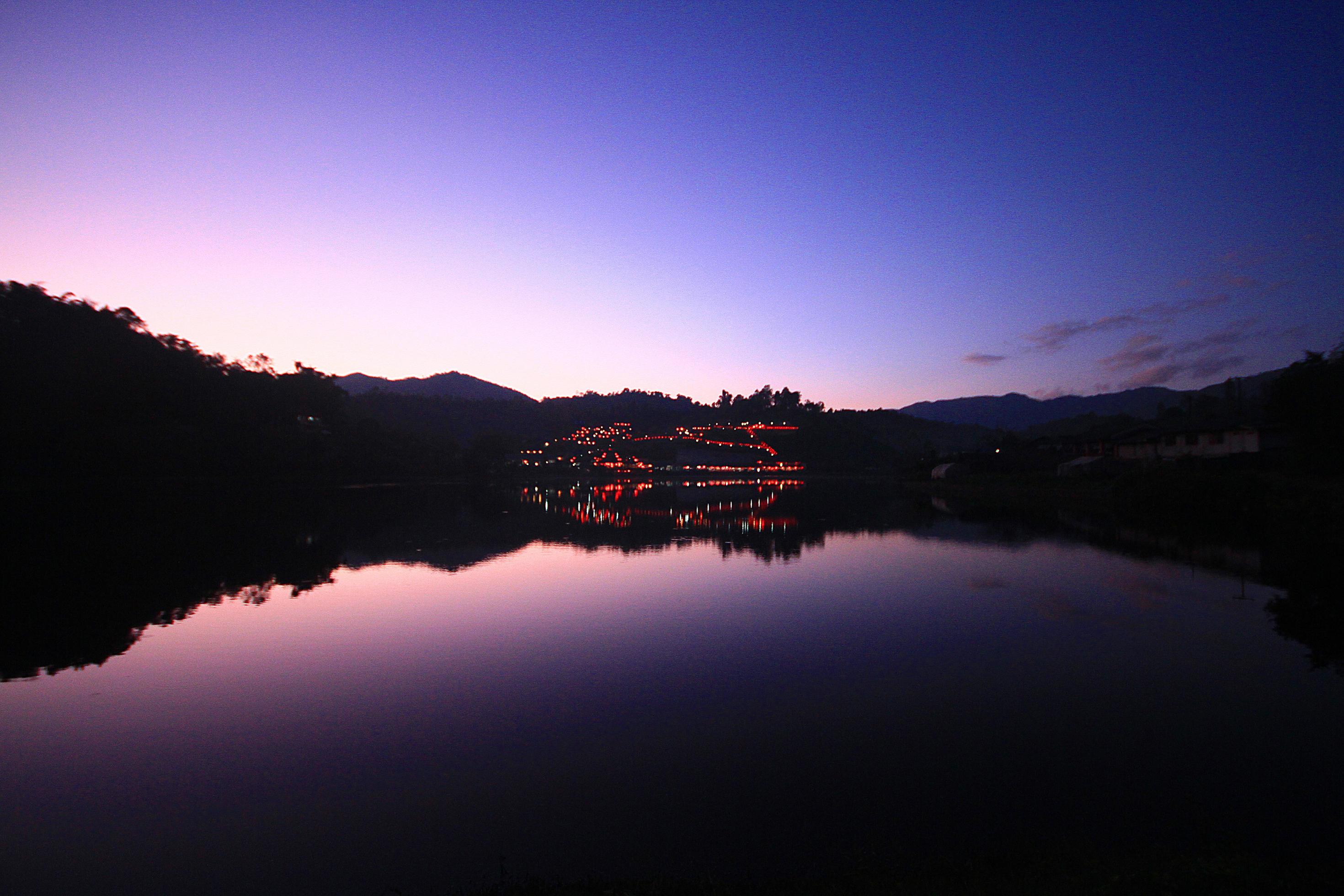 Beautiful sunset and twiligth of sky reflection on water surface and lake at Hill tribe village in Thailand Stock Free