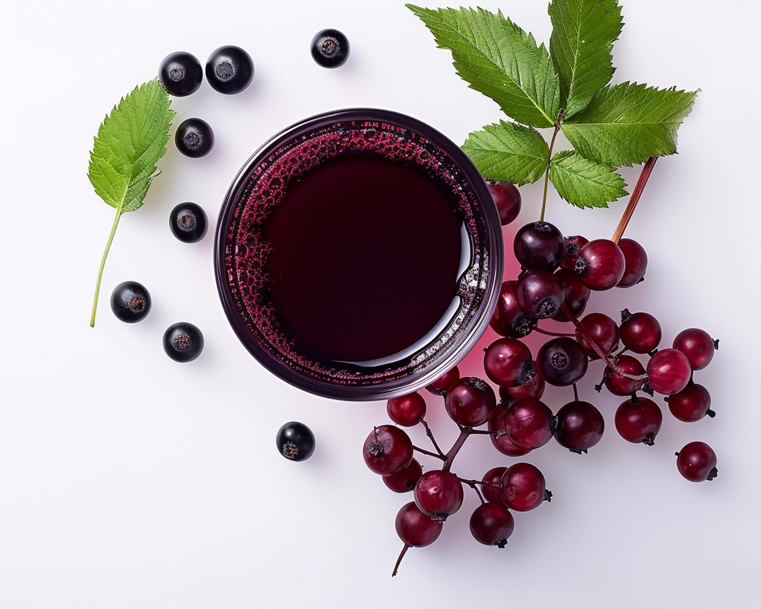 black currant juice with black currant leaves and berries on white background Stock Free