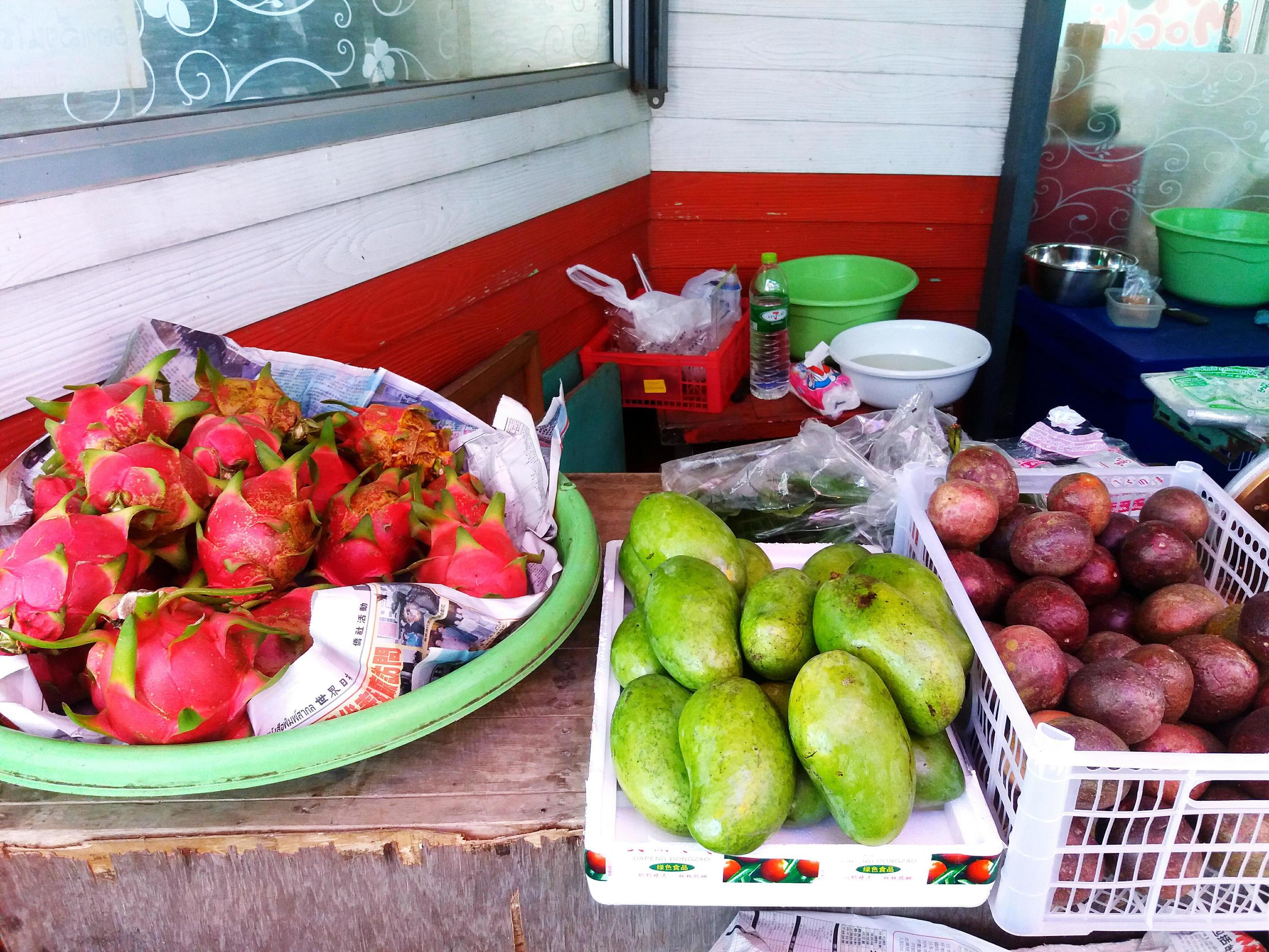 Many fruit with dragon fruit and mango for sale at local street food market. Freshness fruit on basket Stock Free