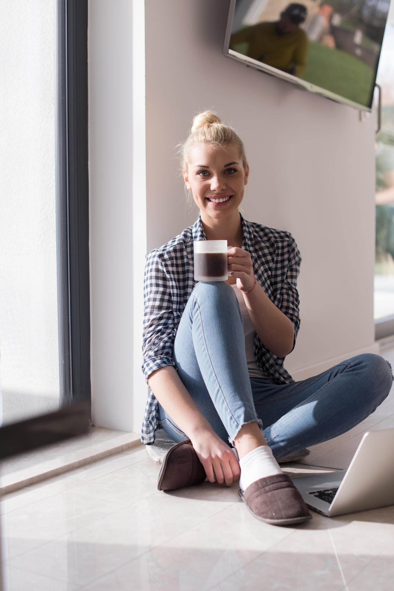 young woman drinking coffee enjoying relaxing lifestyle Stock Free