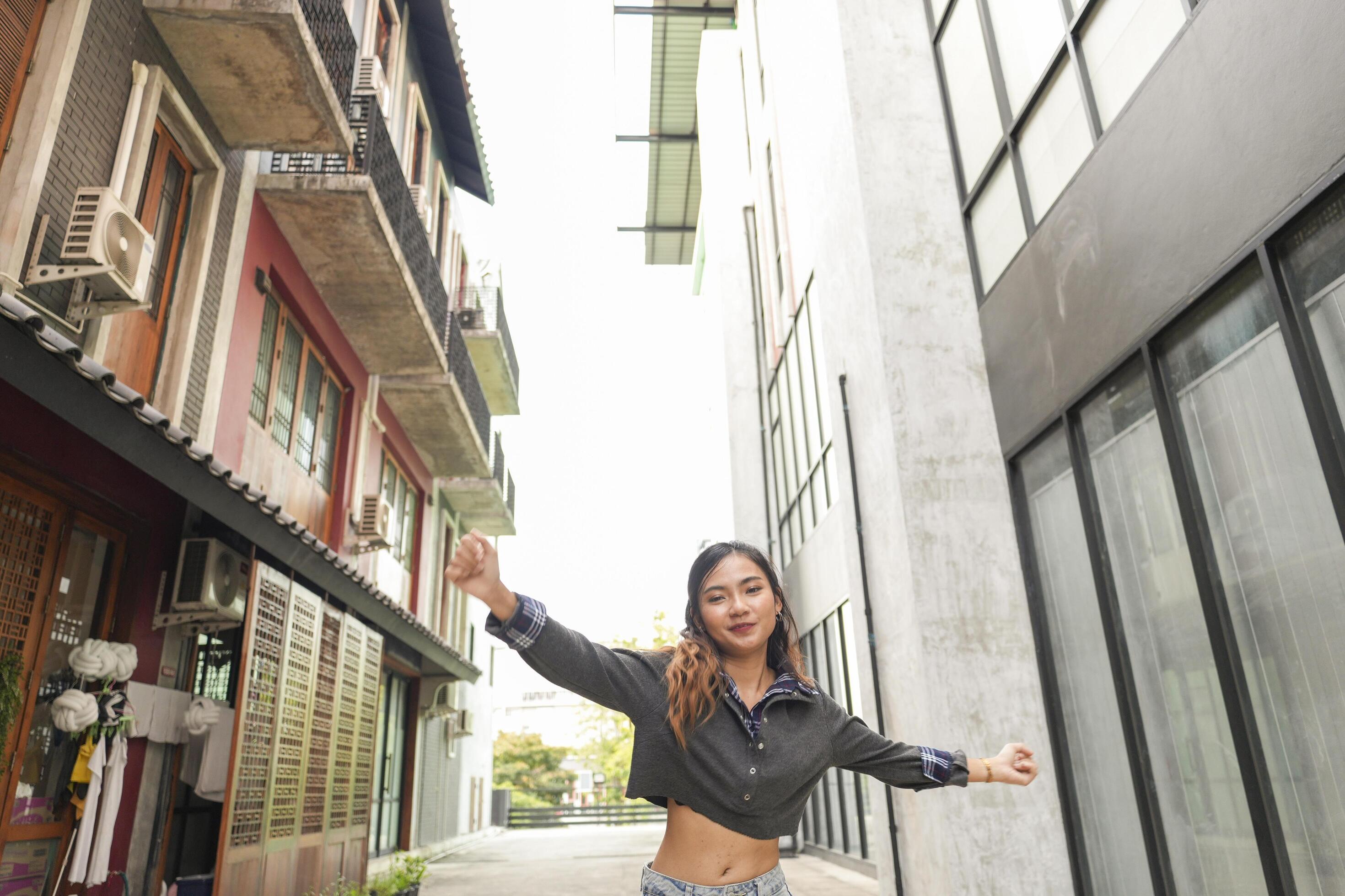 Asian women do freestyle hip hop and breakdancing in a public space in the middle of the city. With a cheerful and happy attitude Stock Free