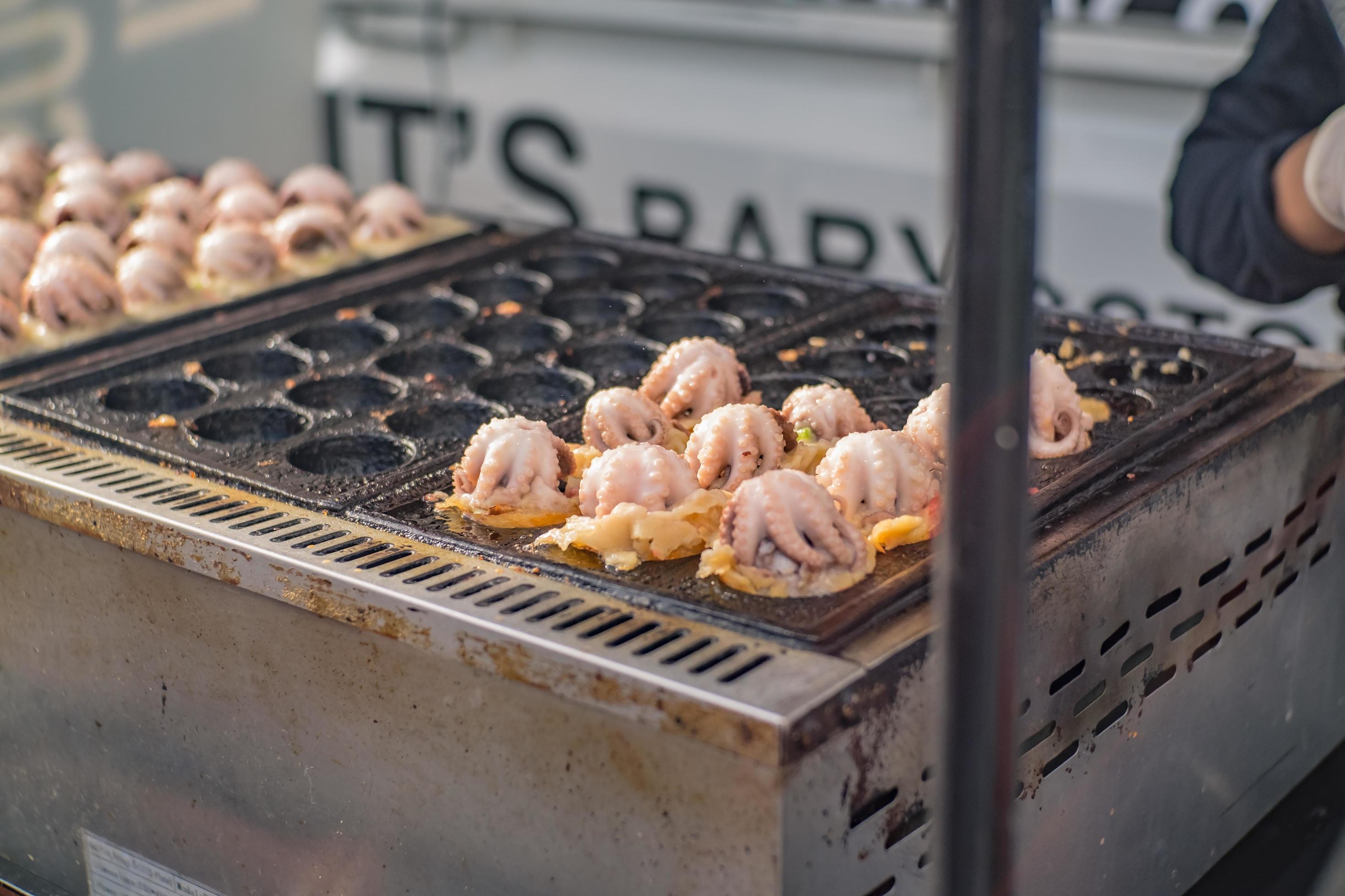 Giant octopus Takoyaki Cooking on Tako stove.Takoyaki The Famous Japan Street Food Stock Free