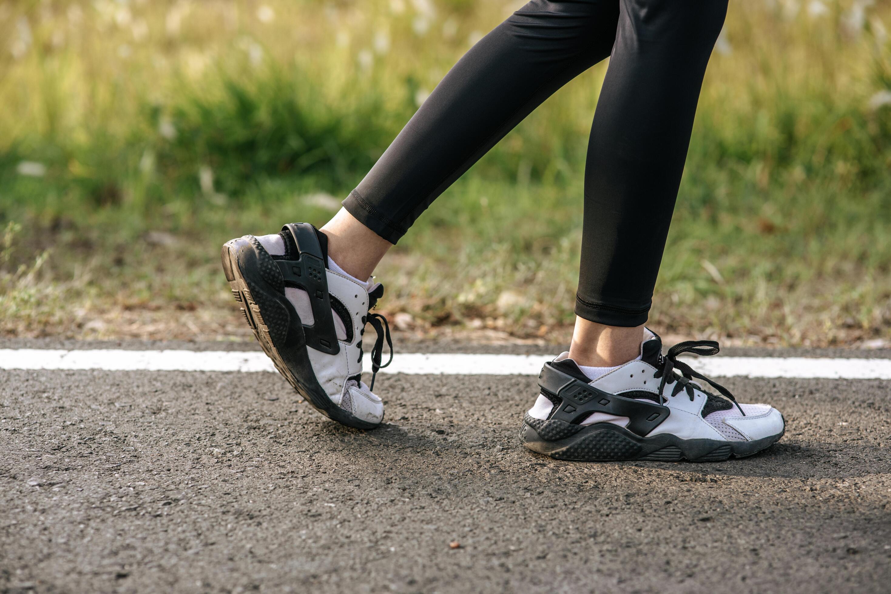 Runner woman feet running on road closeup on shoe. Sports healthy lifestyle concept. Stock Free