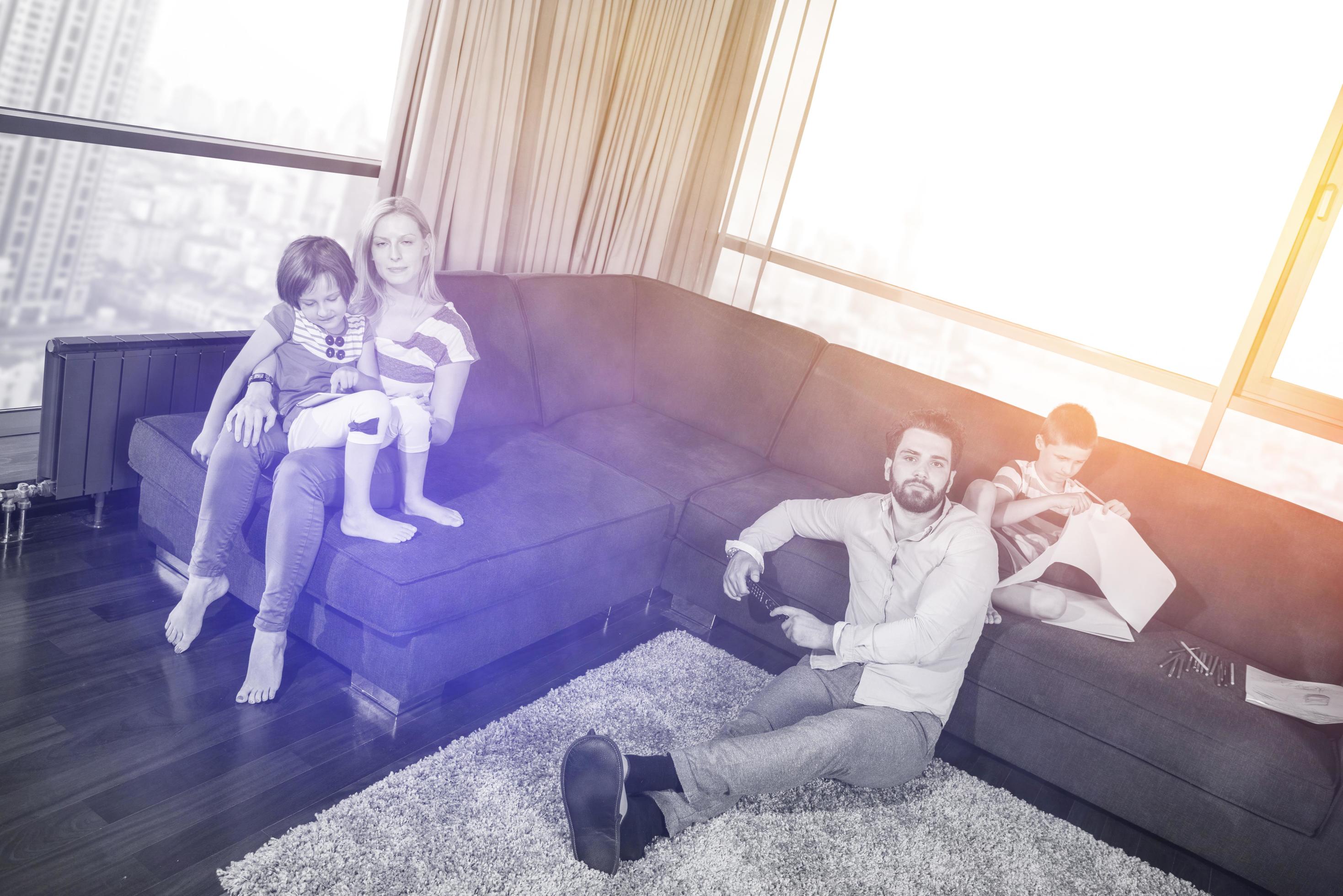 Happy Young Family Playing Together on sofa Stock Free