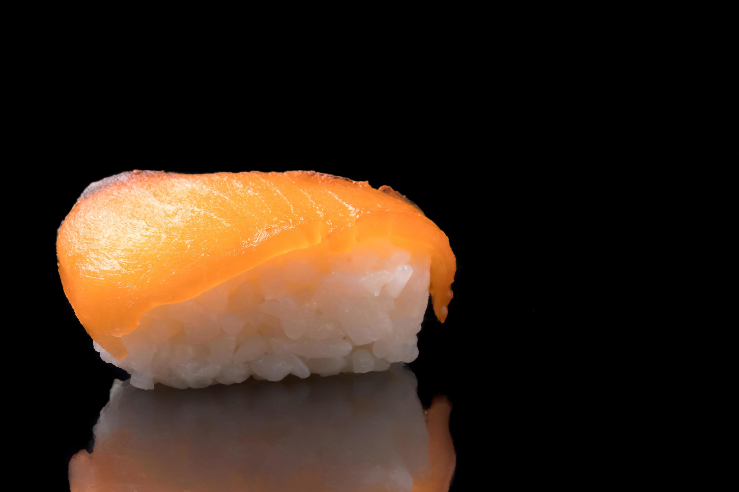 Sushi, japanese food, rice with salmon on black background. Stock Free