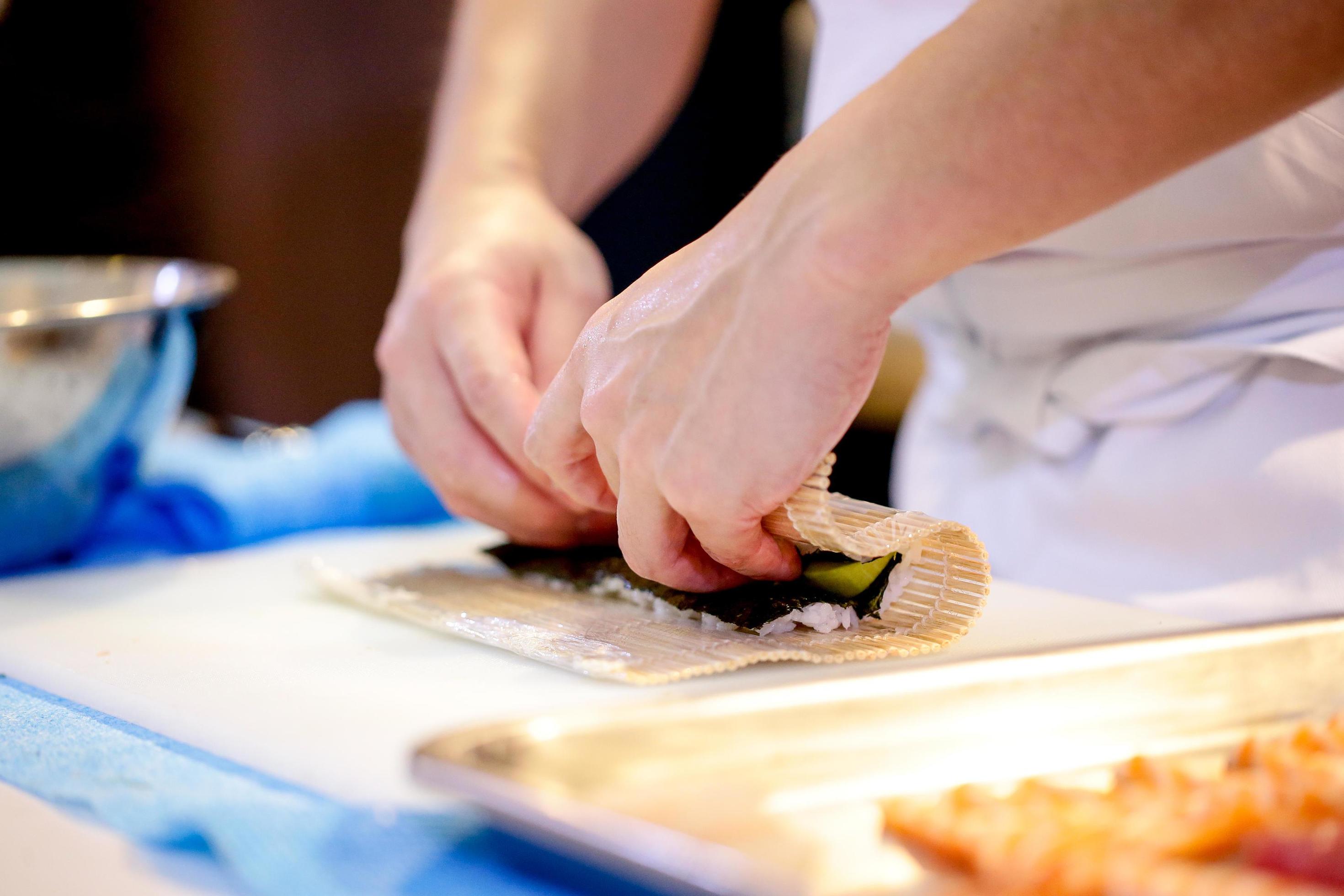 chef hands preparing japanese food, chef making sushi Stock Free