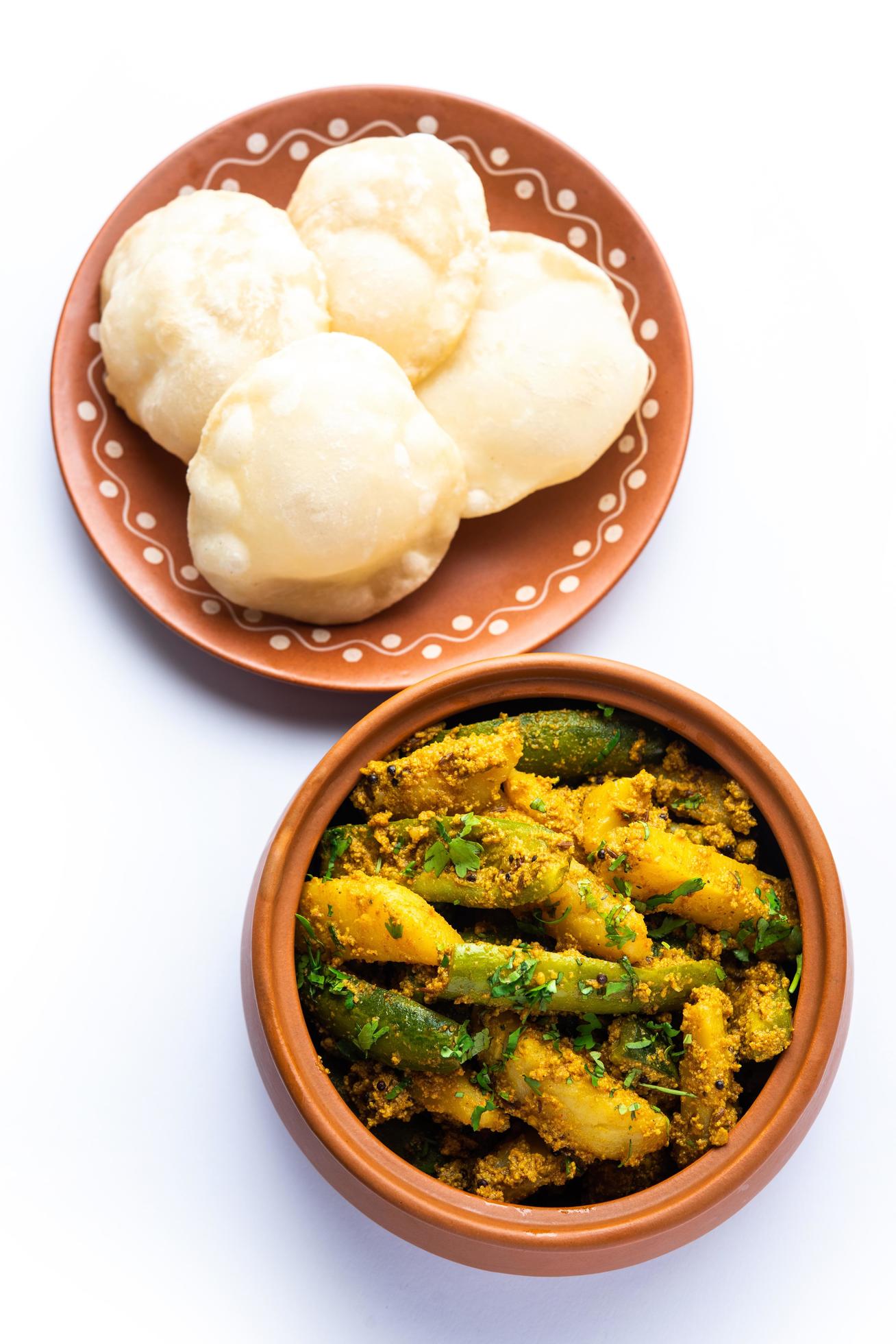 Aloo Patol sabzi made using pointed gourd and potato served with fried Luchi or poori, Bengali food Stock Free