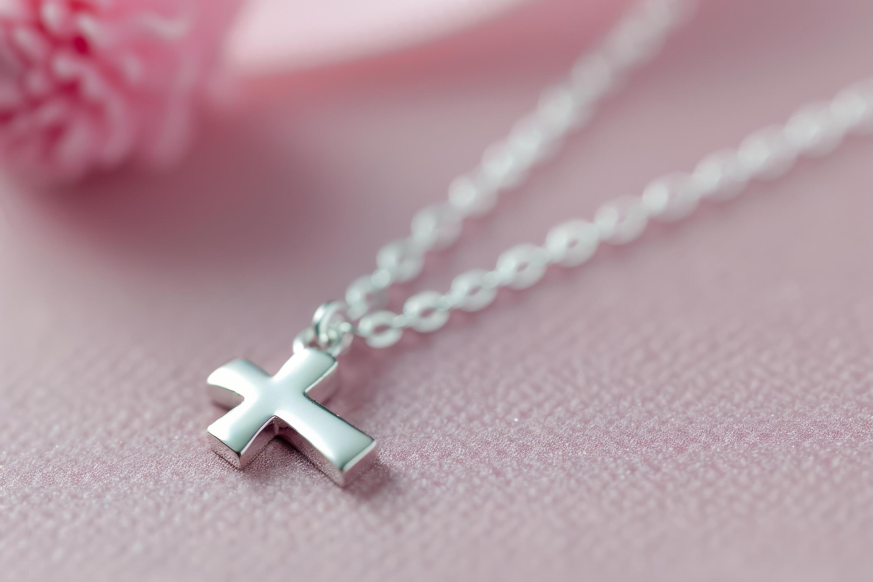 Silver Cross Necklace on Pink Background Stock Free