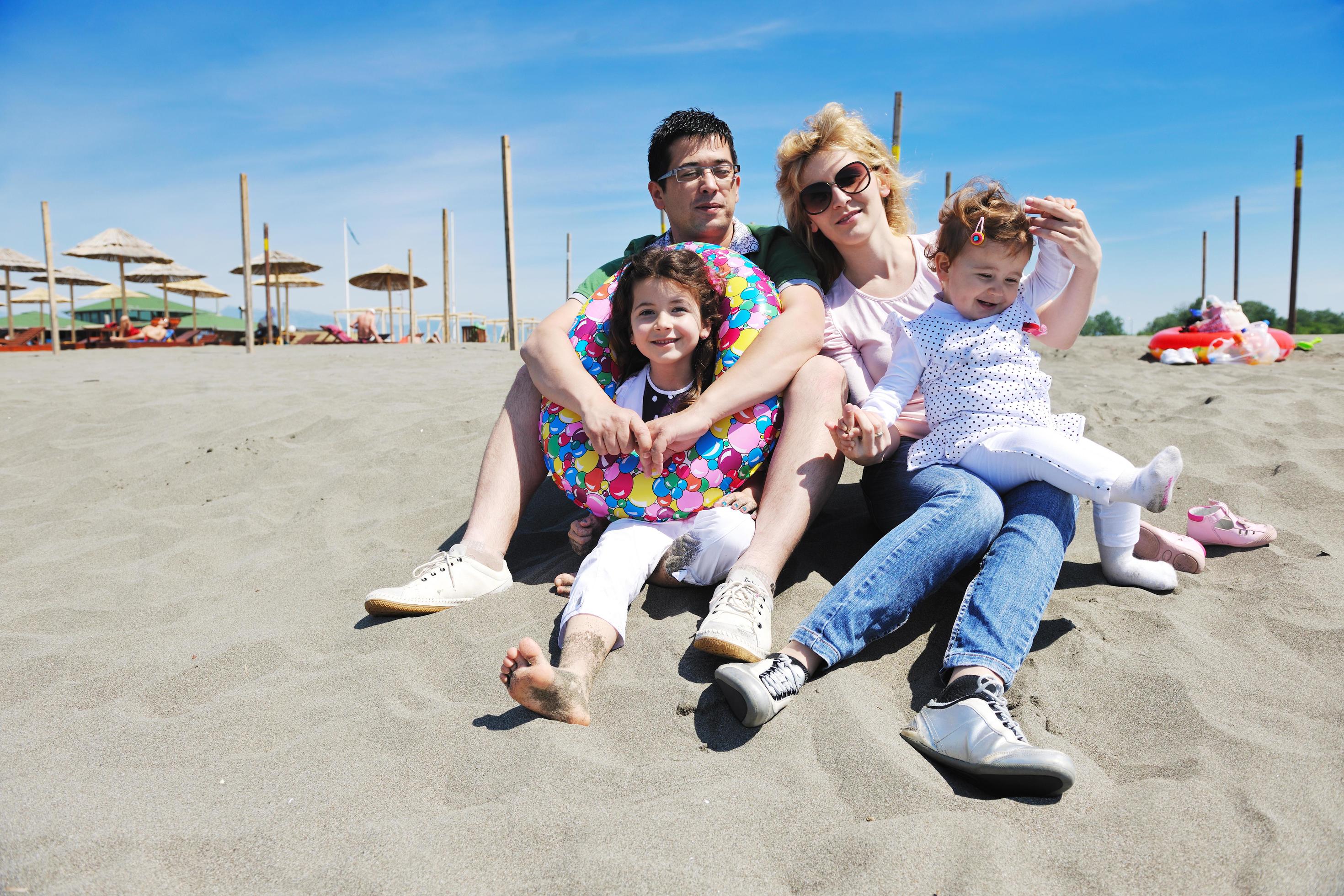 happy young family have fun on beach Stock Free