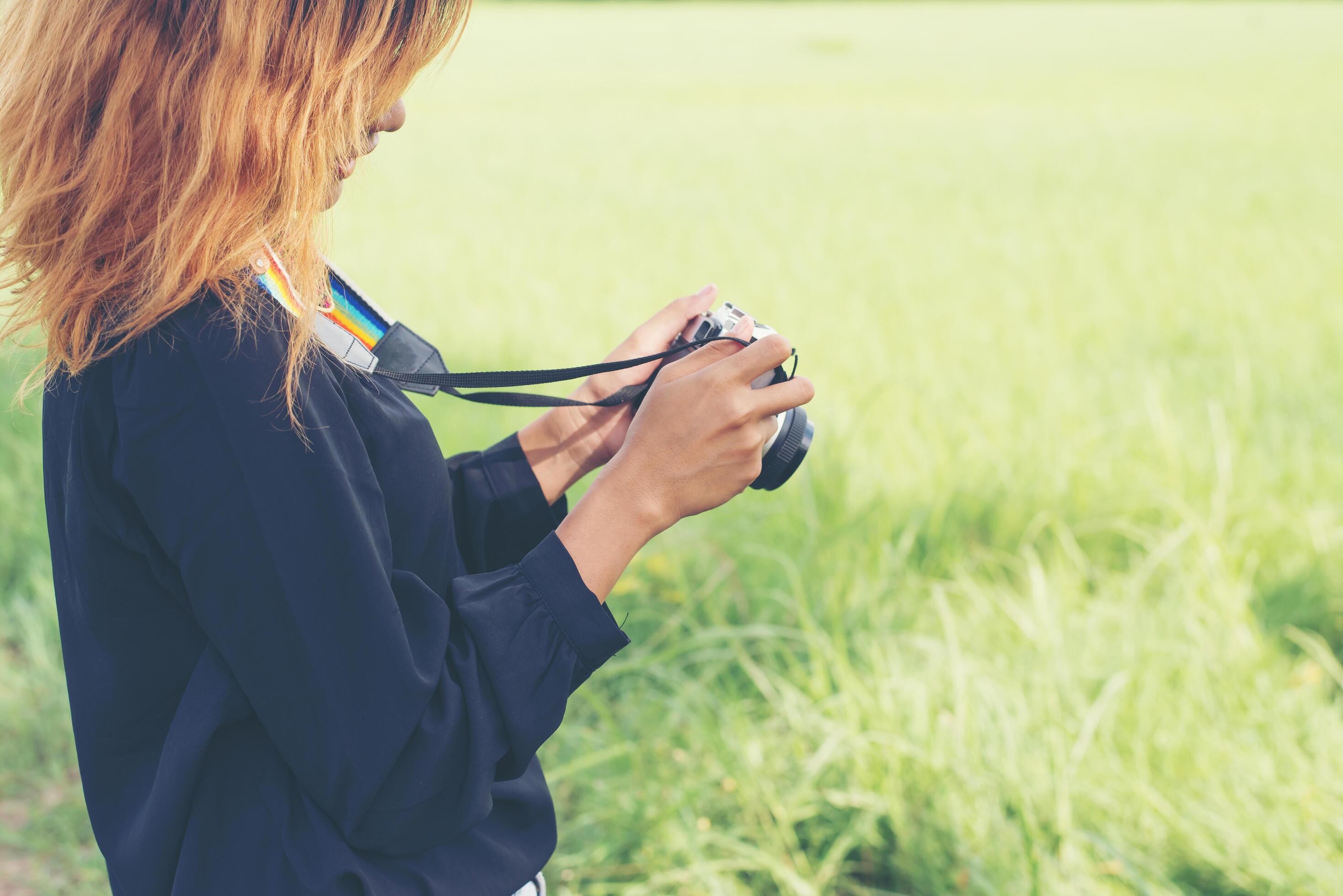 Woman with retro camera, hipster lifestyle look Stock Free