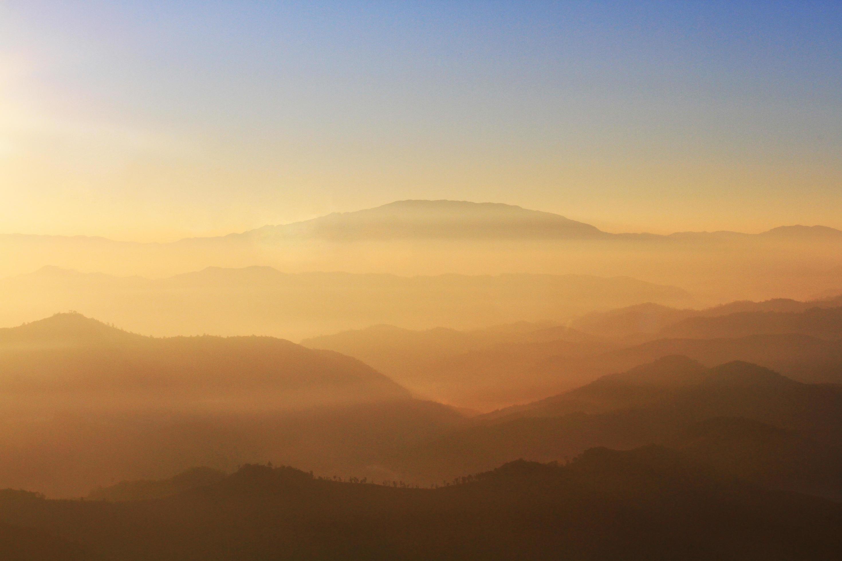 Beautiful Sunset and sunrise on sky and golden twilight time with mist and fog in valley of mountain layer Stock Free