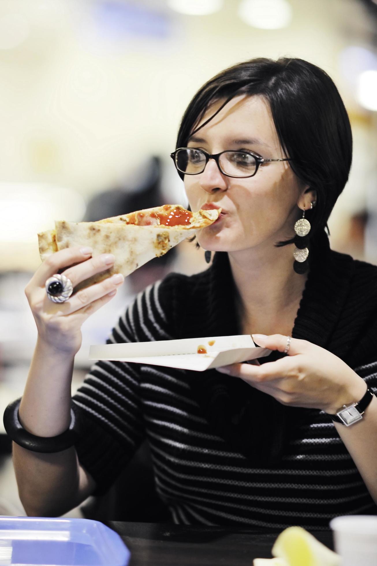 woman eat pizza food at restaurant Stock Free