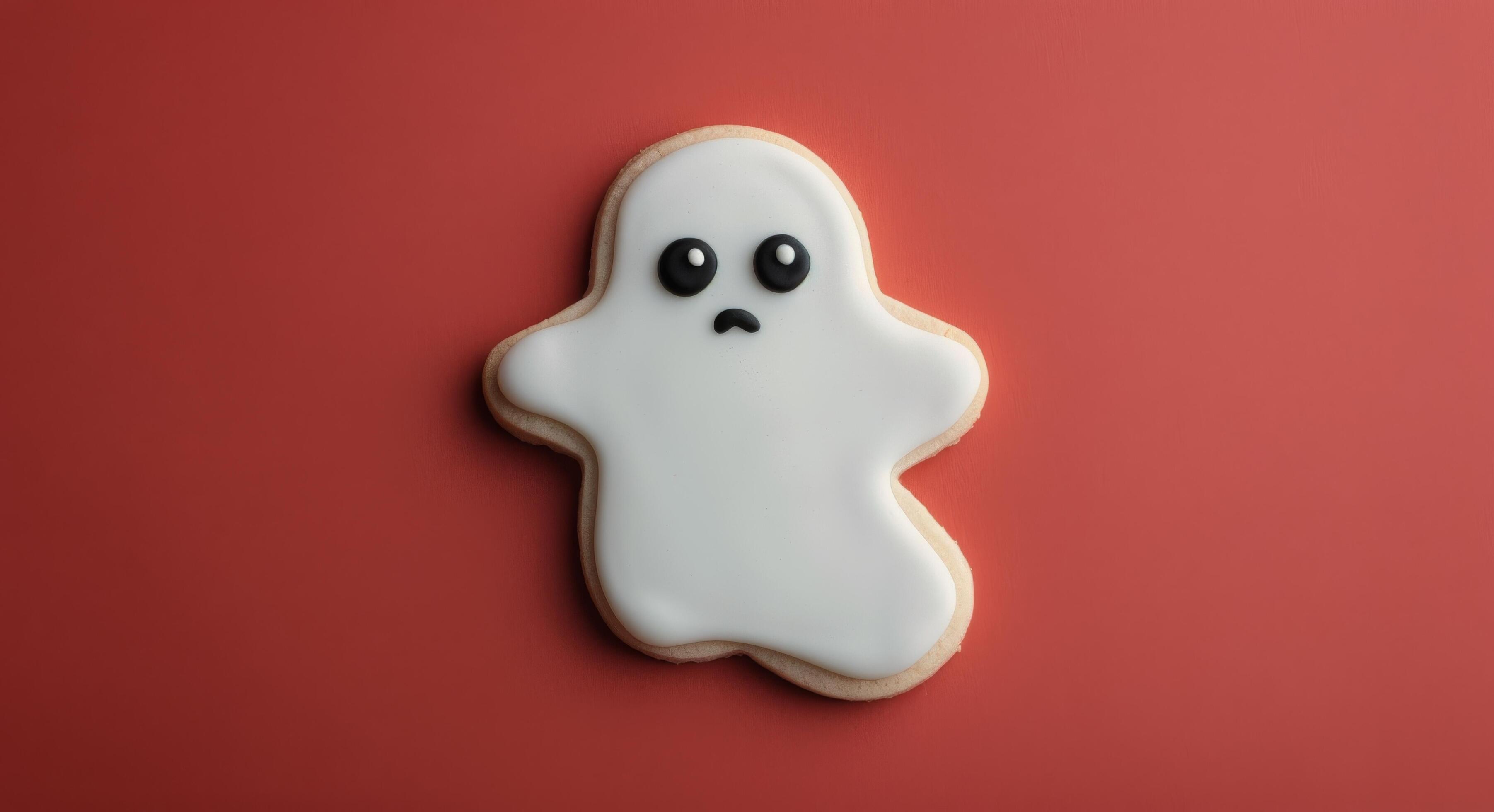 Cute Ghost-Shaped Cookie on Red Background for Halloween Celebration Stock Free