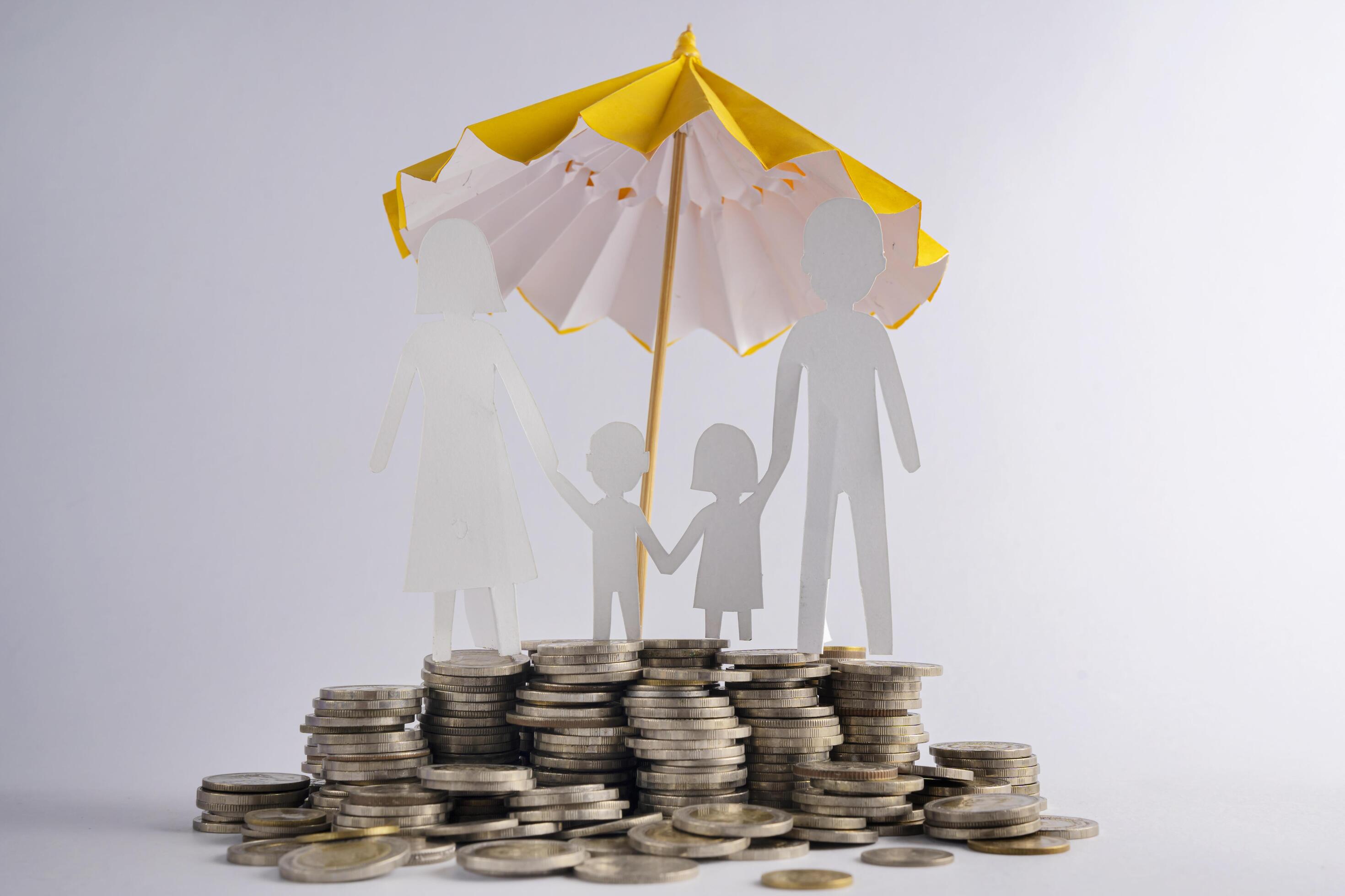 Coin stacks with family with the protect umbrella on dark background , business idea and insurance concept Stock Free